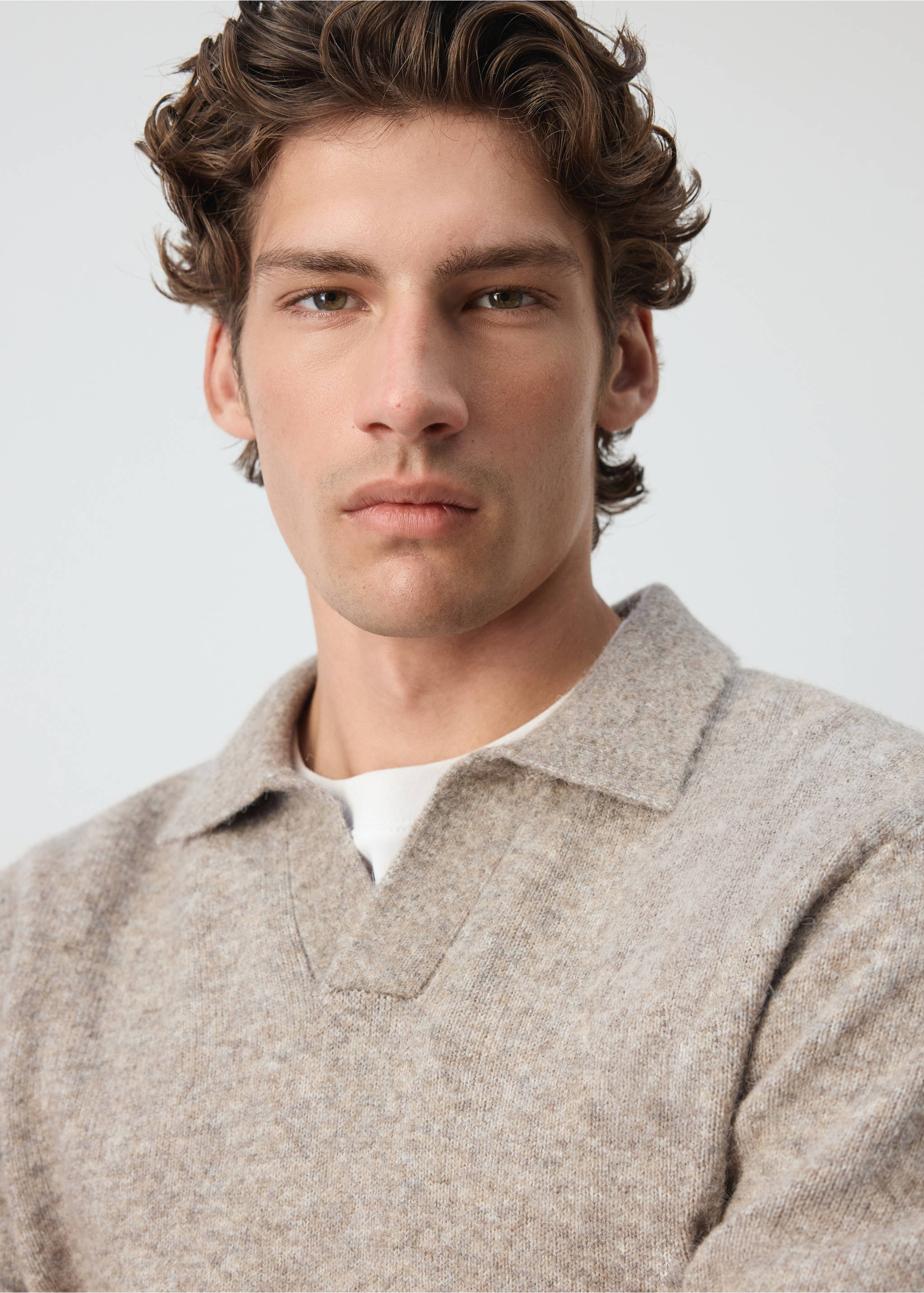 Close-up of a textured beige marled knit polo shirt with a V-neckline., Beige. Ref: 37047916-00.