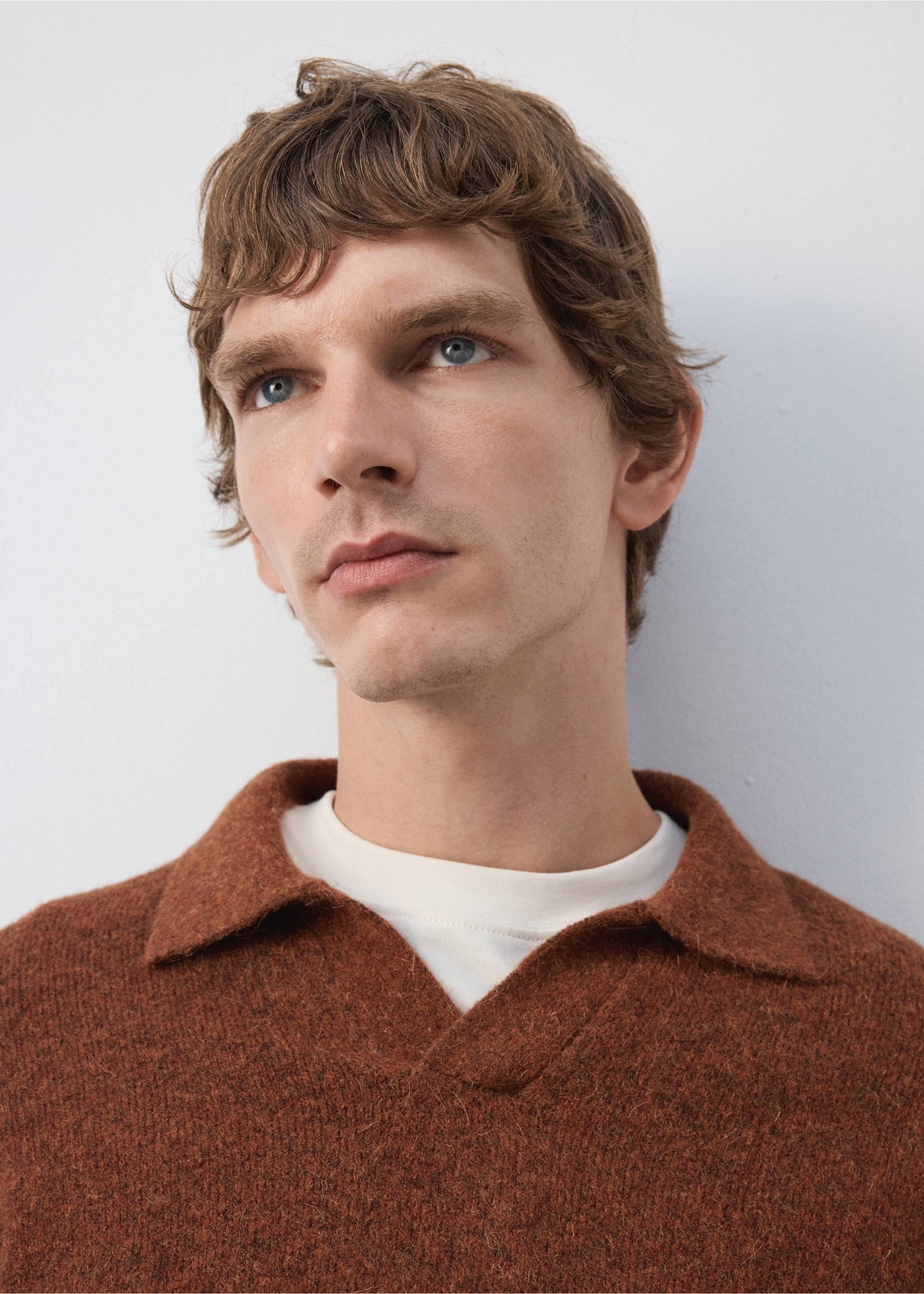 Brown textured knit polo shirt with an open V-neck collar worn over a white t-shirt., Burnt Orange. Ref: 37047916-00.