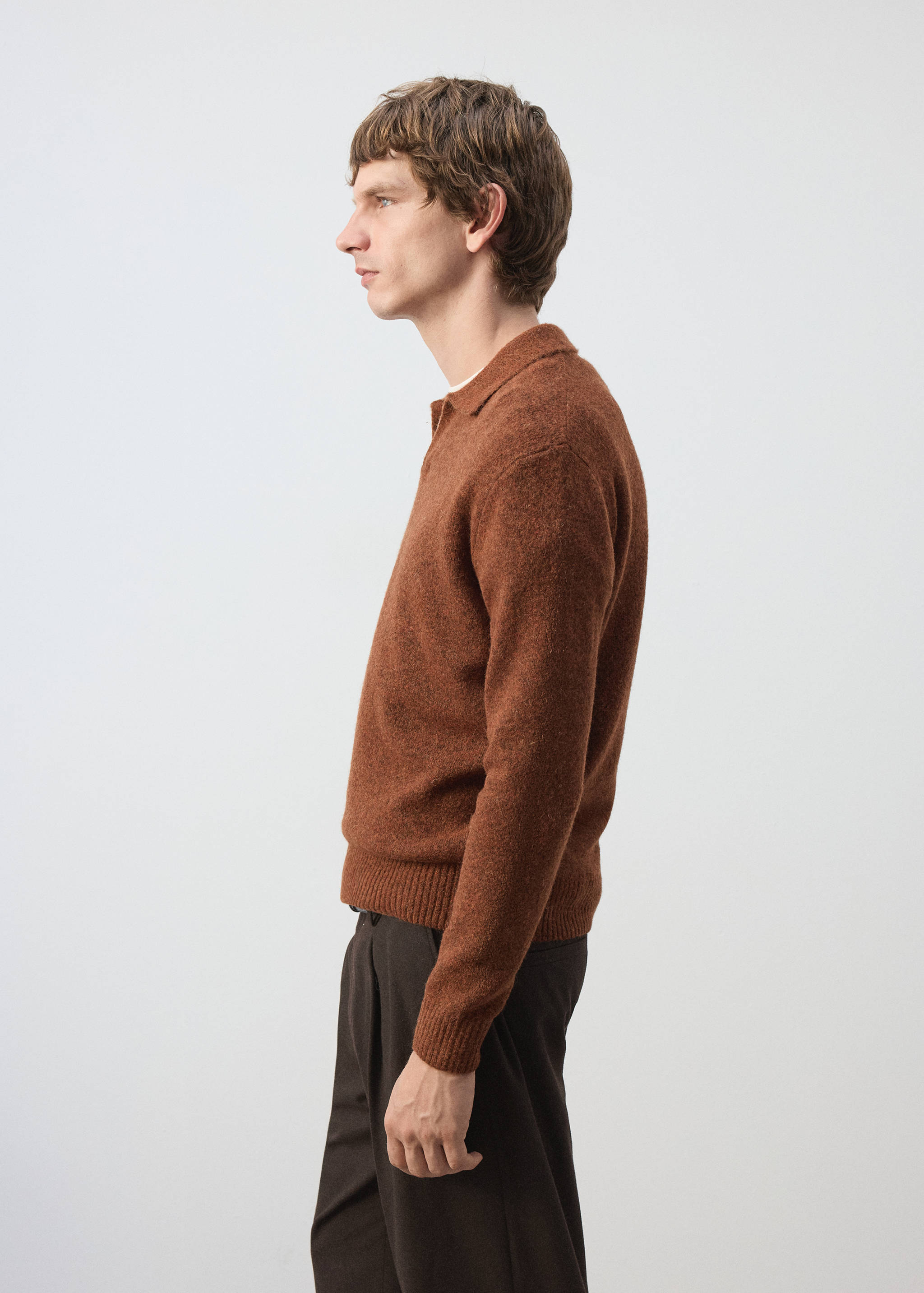Brown knitted polo shirt with a classic collar and long sleeves.