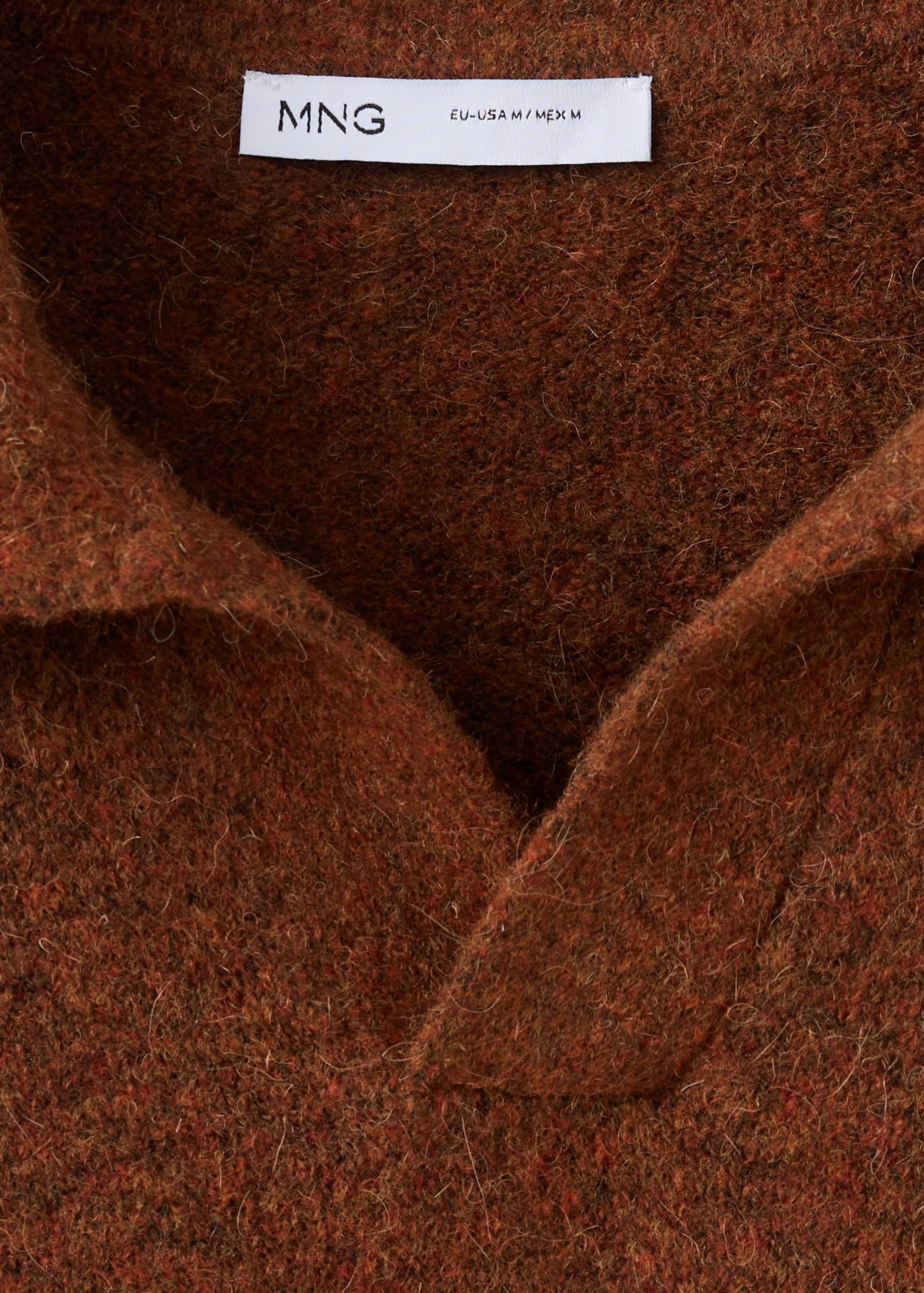 Close-up of a textured brown polo shirt collar.