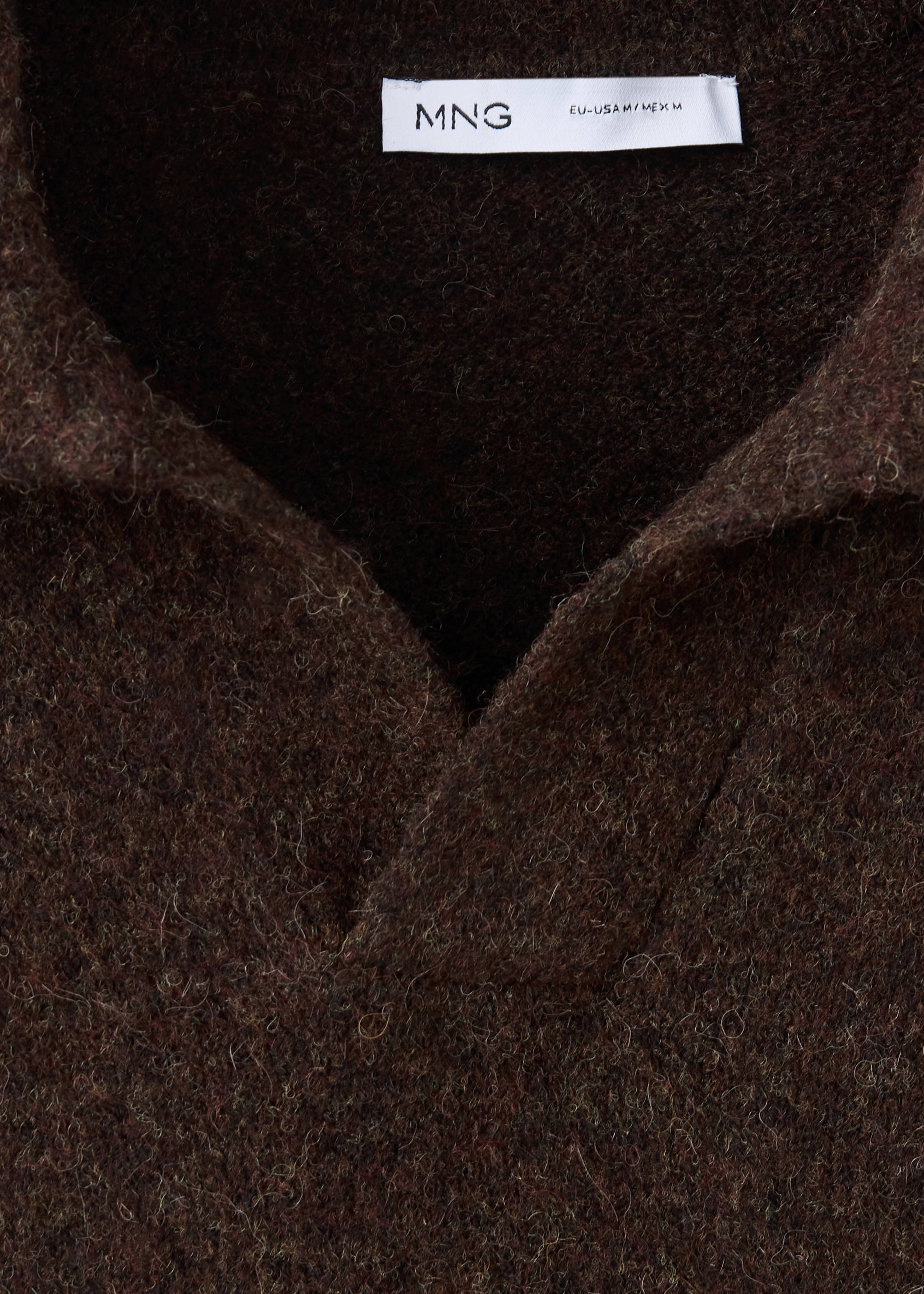 Close-up of a dark brown fuzzy knit polo collar and neckline.