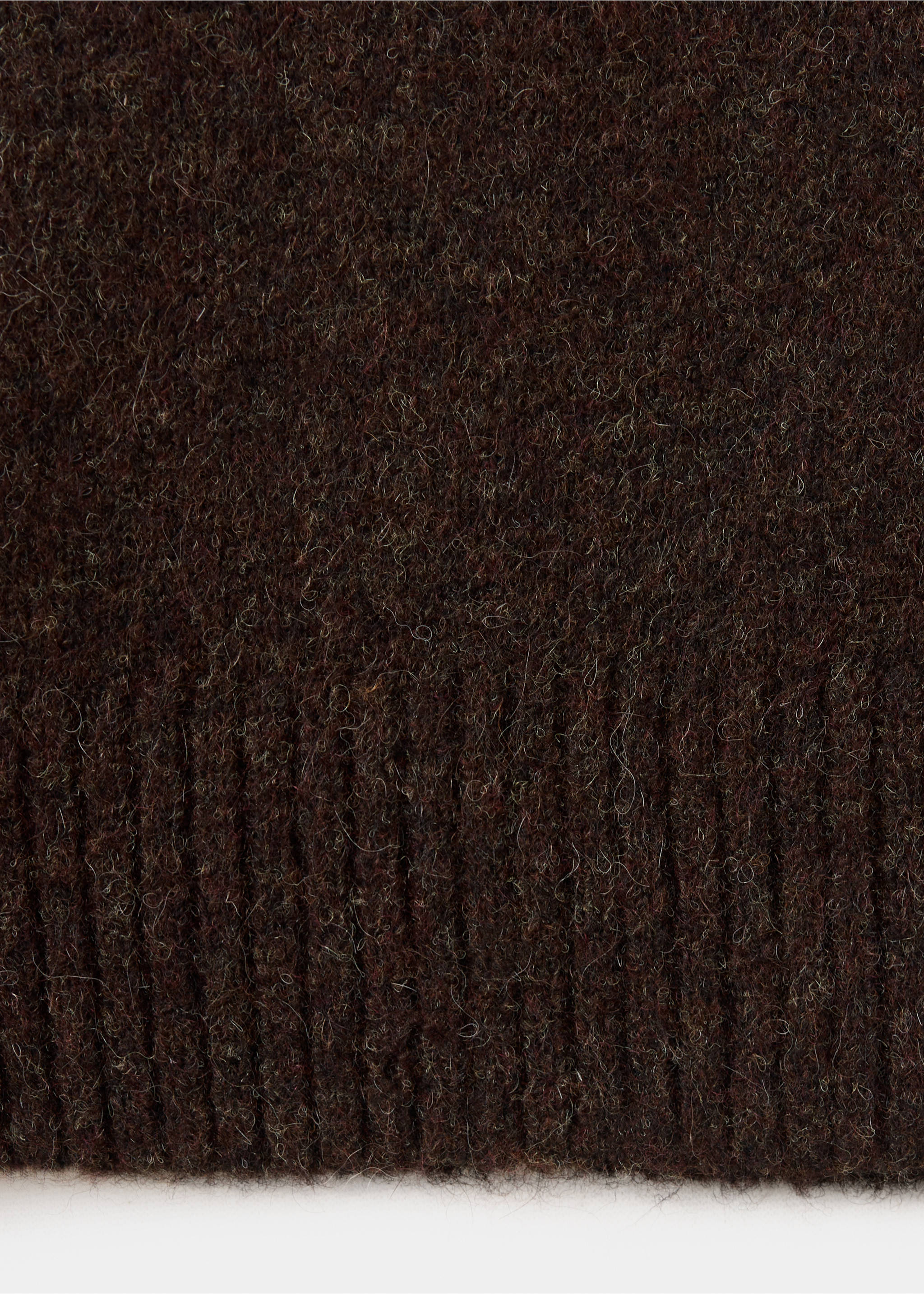 Close-up of the textured brown knit fabric and ribbed hem of a polo., Chocolate. Ref: 37047916-00.
