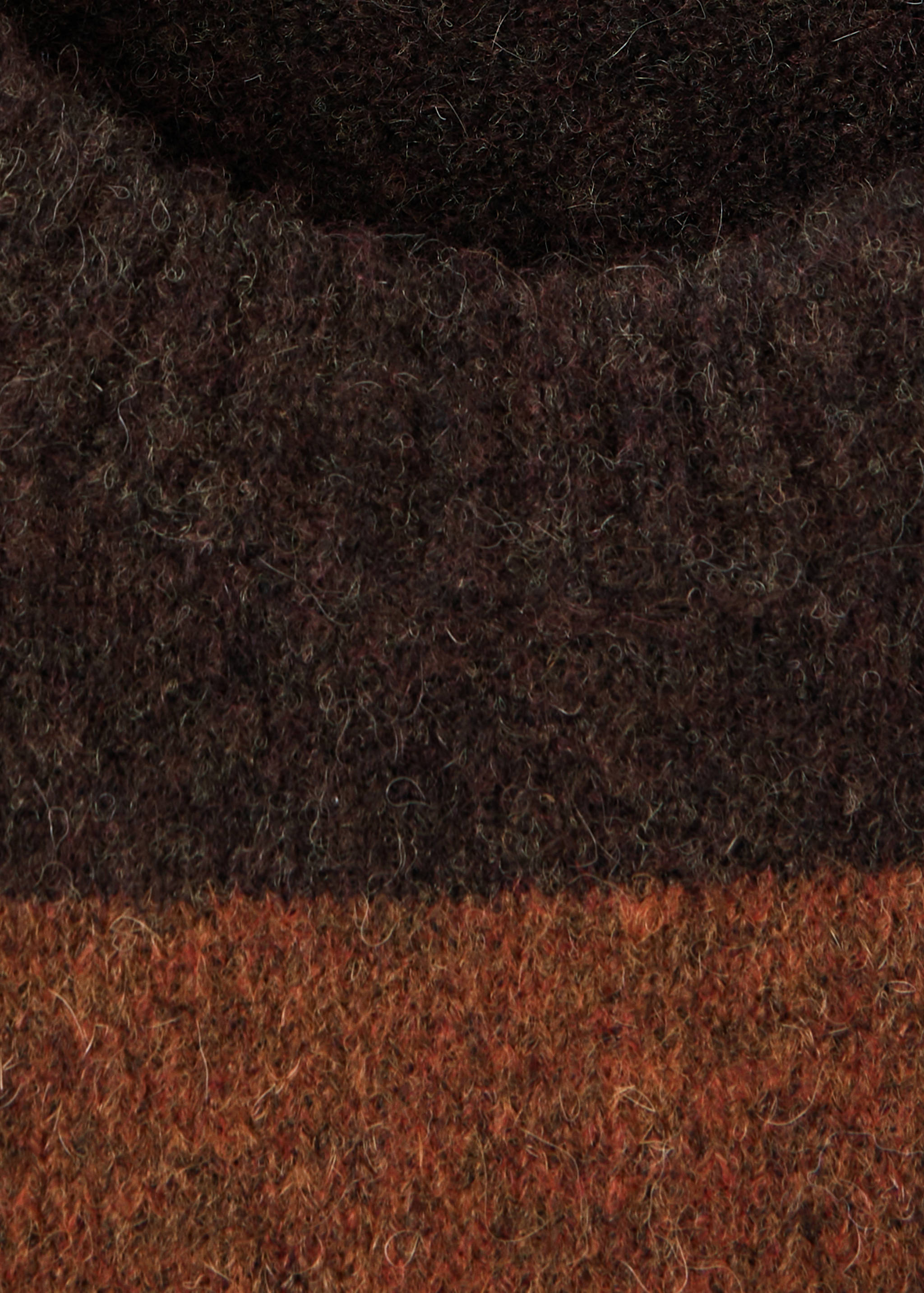 Close-up of a dark brown and rust-orange knitted jersey with a hairy, brushed texture.