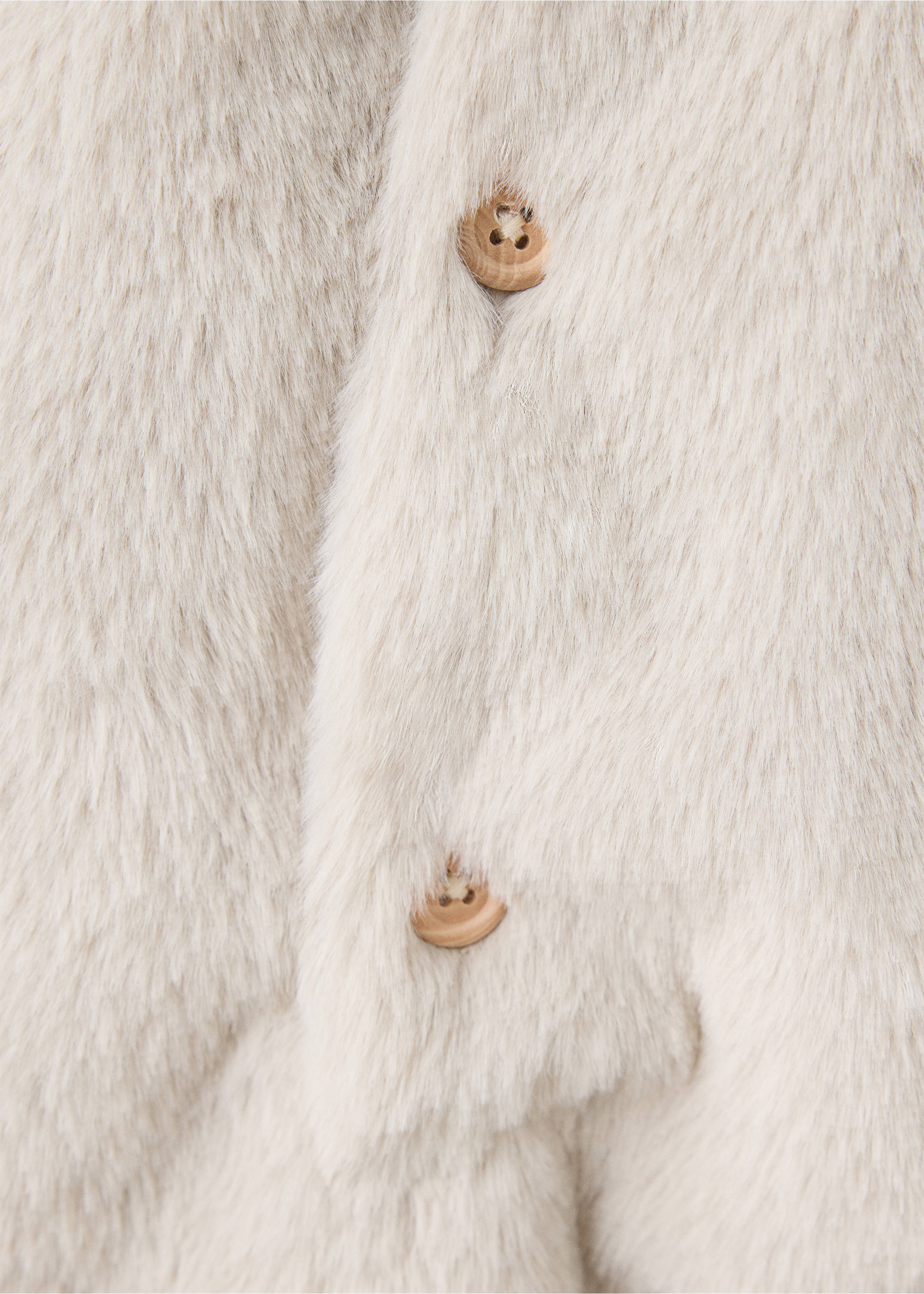 Close-up of a cream kids' faux-fur coat with wooden buttons., Sand. Ref: 37047918-00.