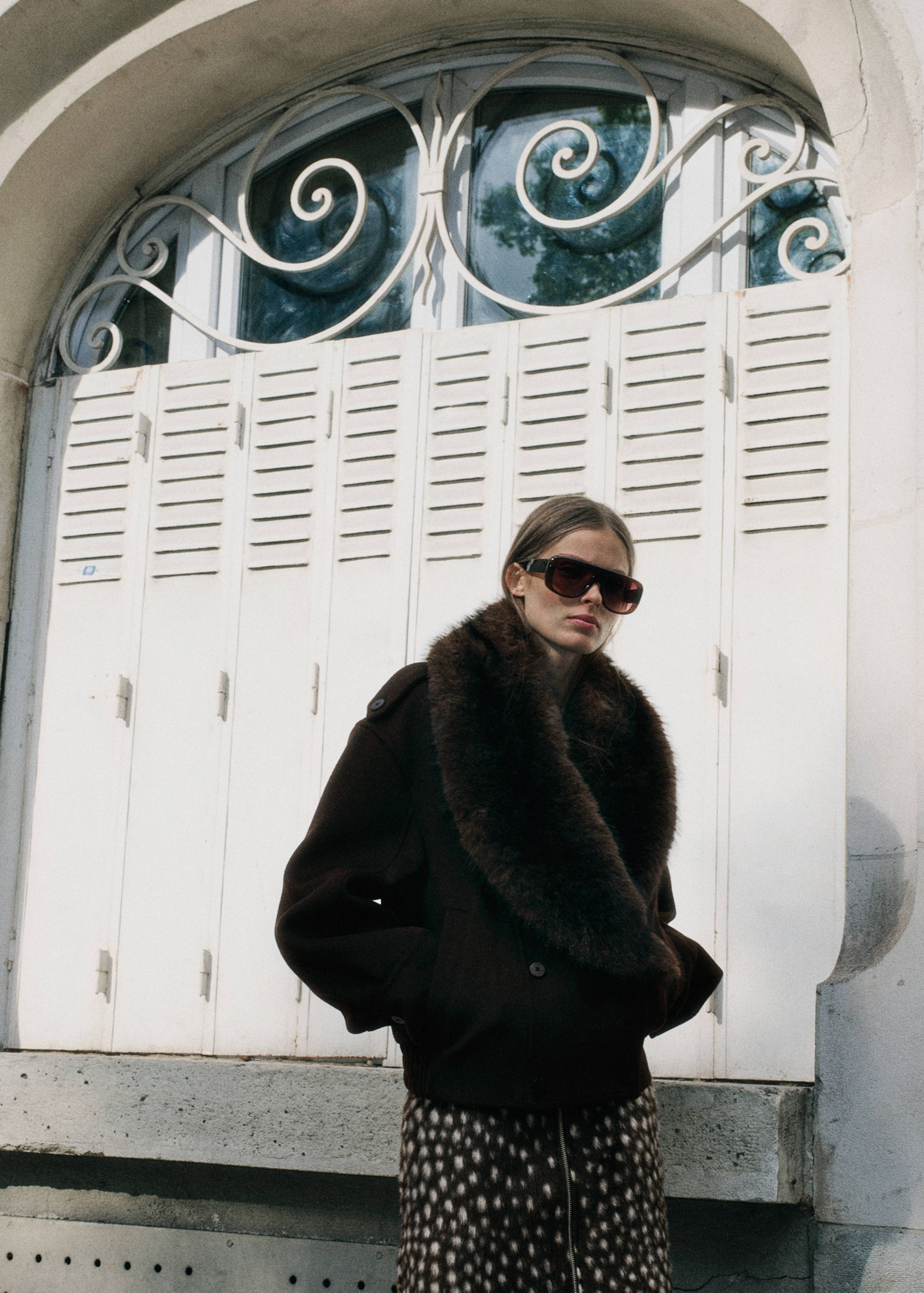 Dark brown jacket featuring a faux-fur shawl collar.