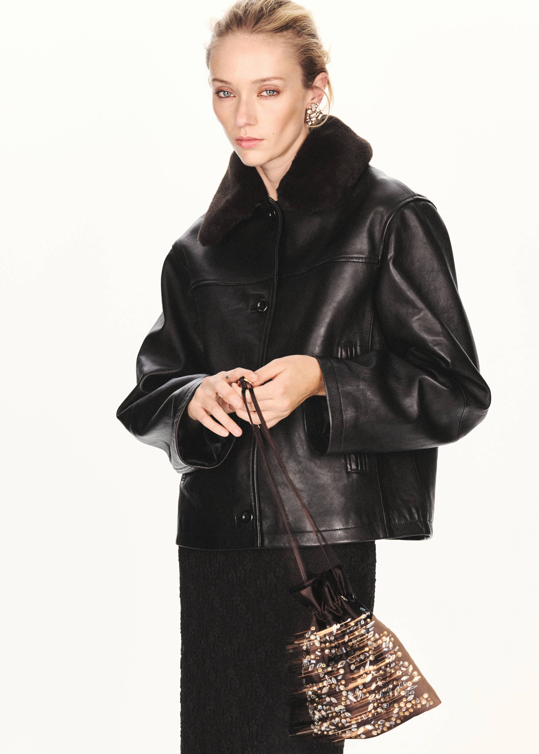 Dark brown embellished pouch handbag with a drawstring closure and sparkling rhinestones.