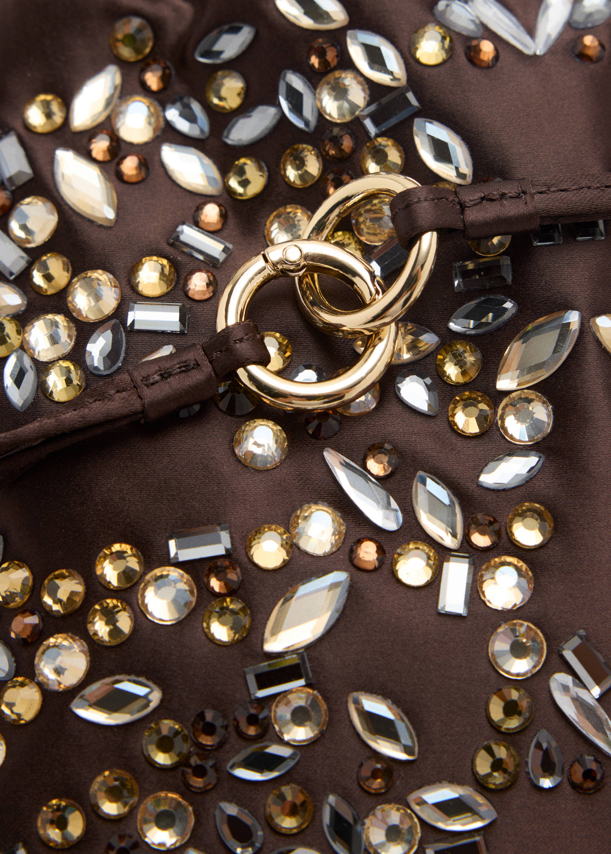 Brown rhinestone-embellished handbag detail with gold rings.