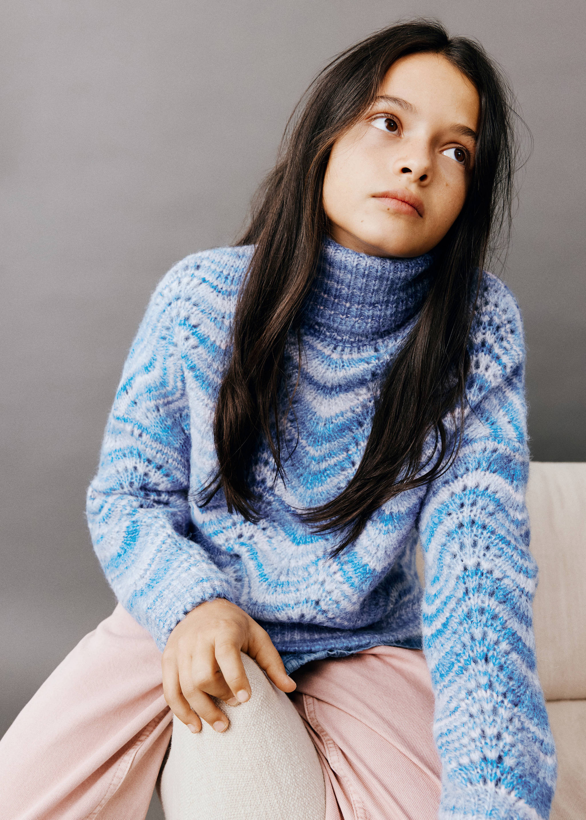 Blue patterned roll-neck jumper in a textured knit.