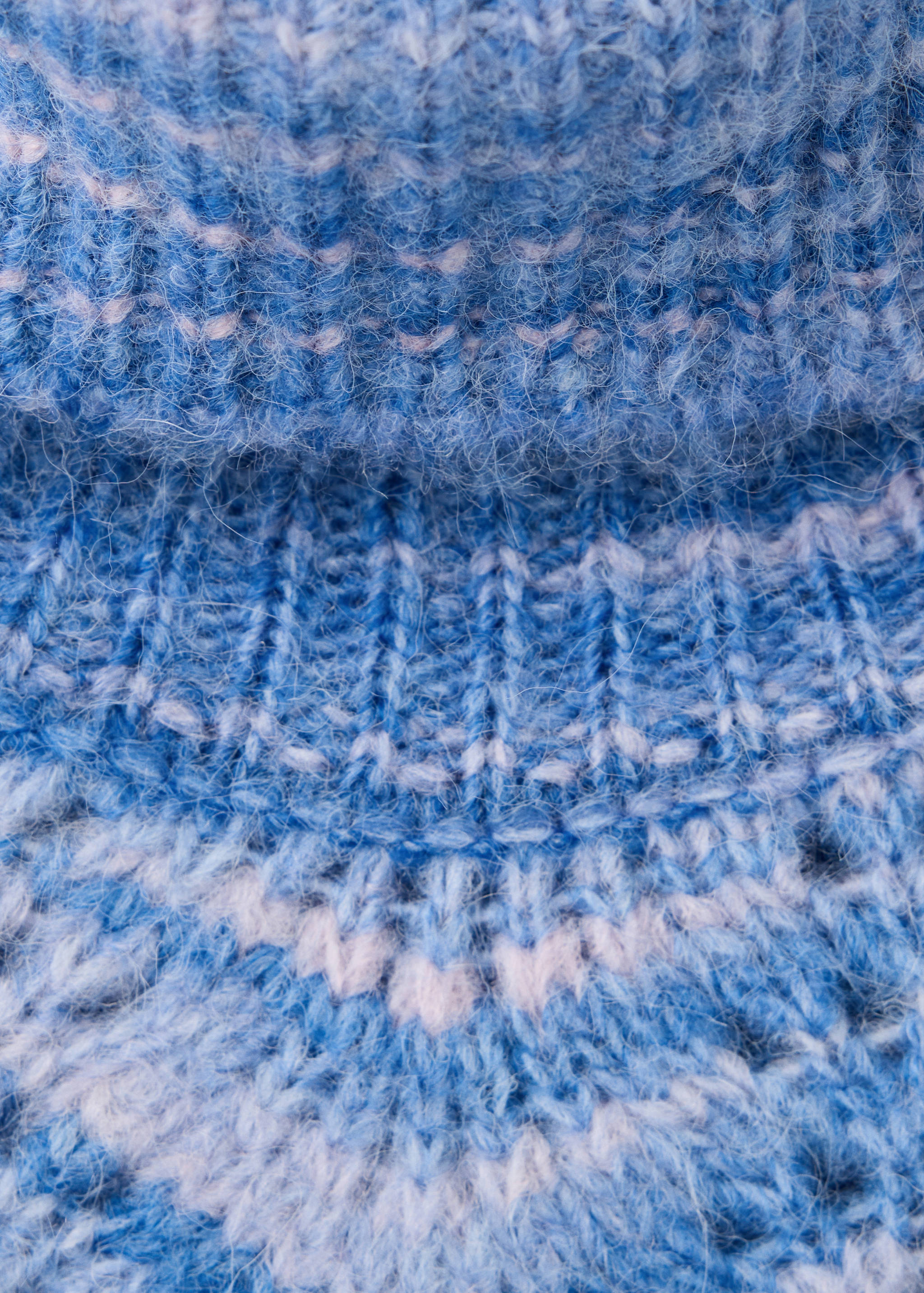 Close-up of a fluffy blue and pink knitted jumper with a ribbed collar.