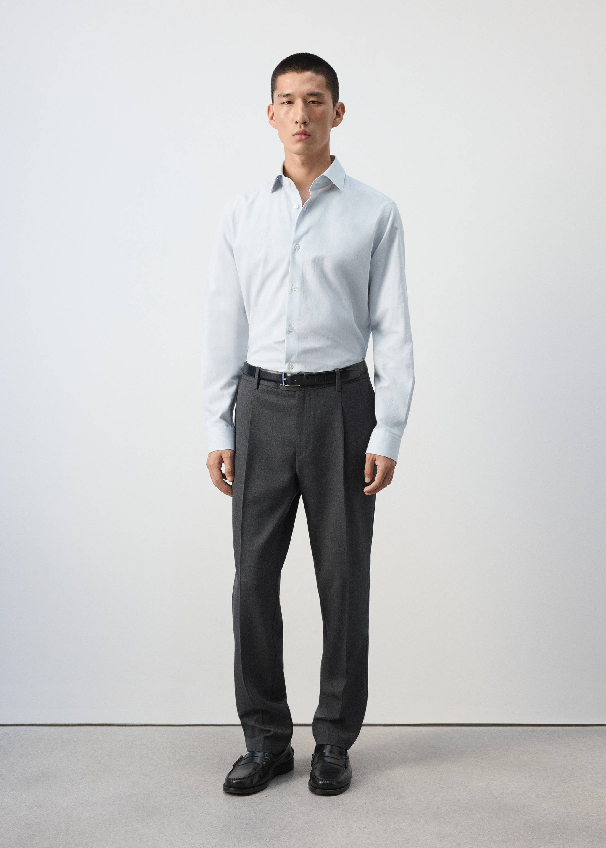 Light blue long-sleeved shirt with a button-up front and classic collar.