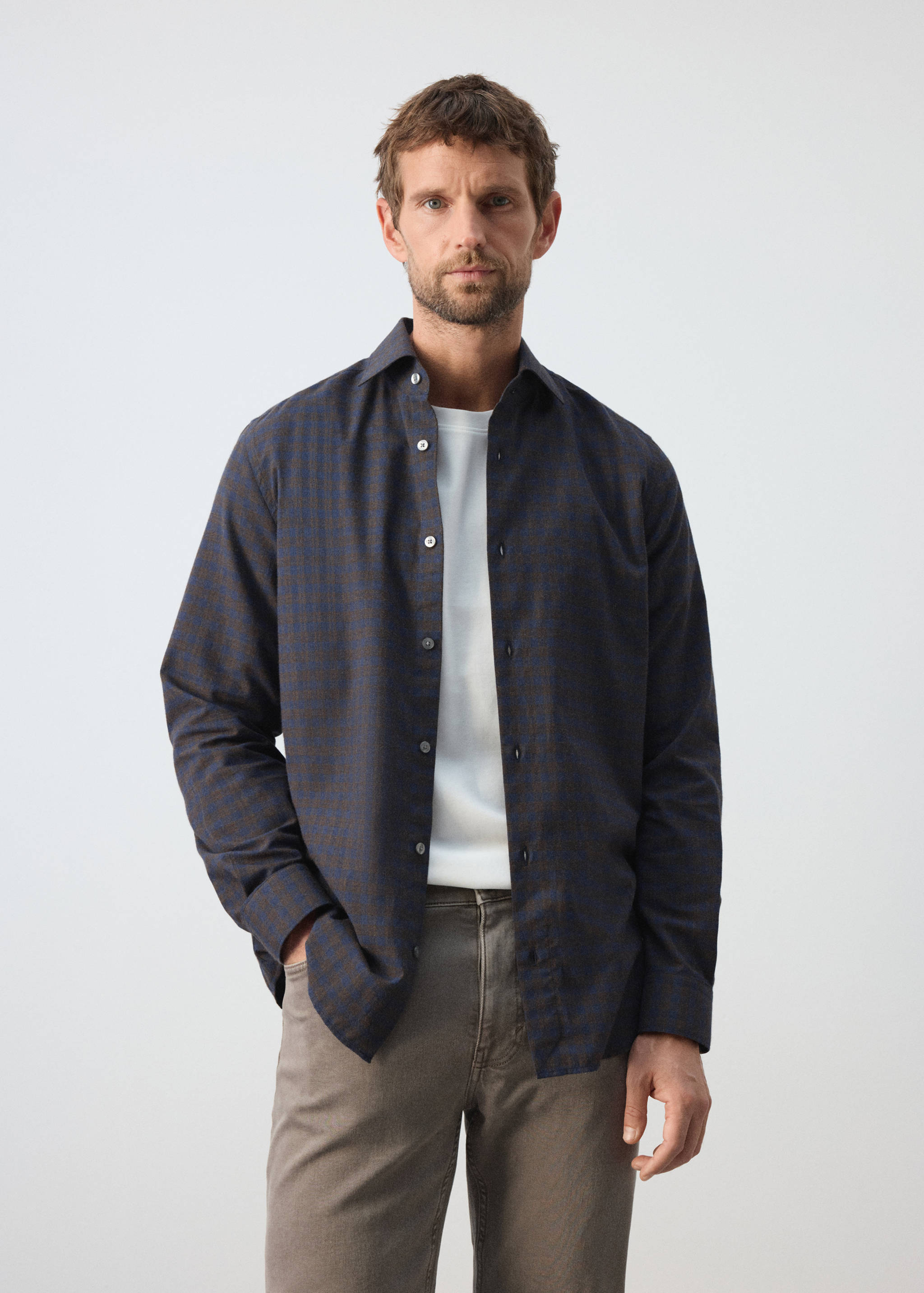 Navy and brown checked shirt with long sleeves and a classic collar.