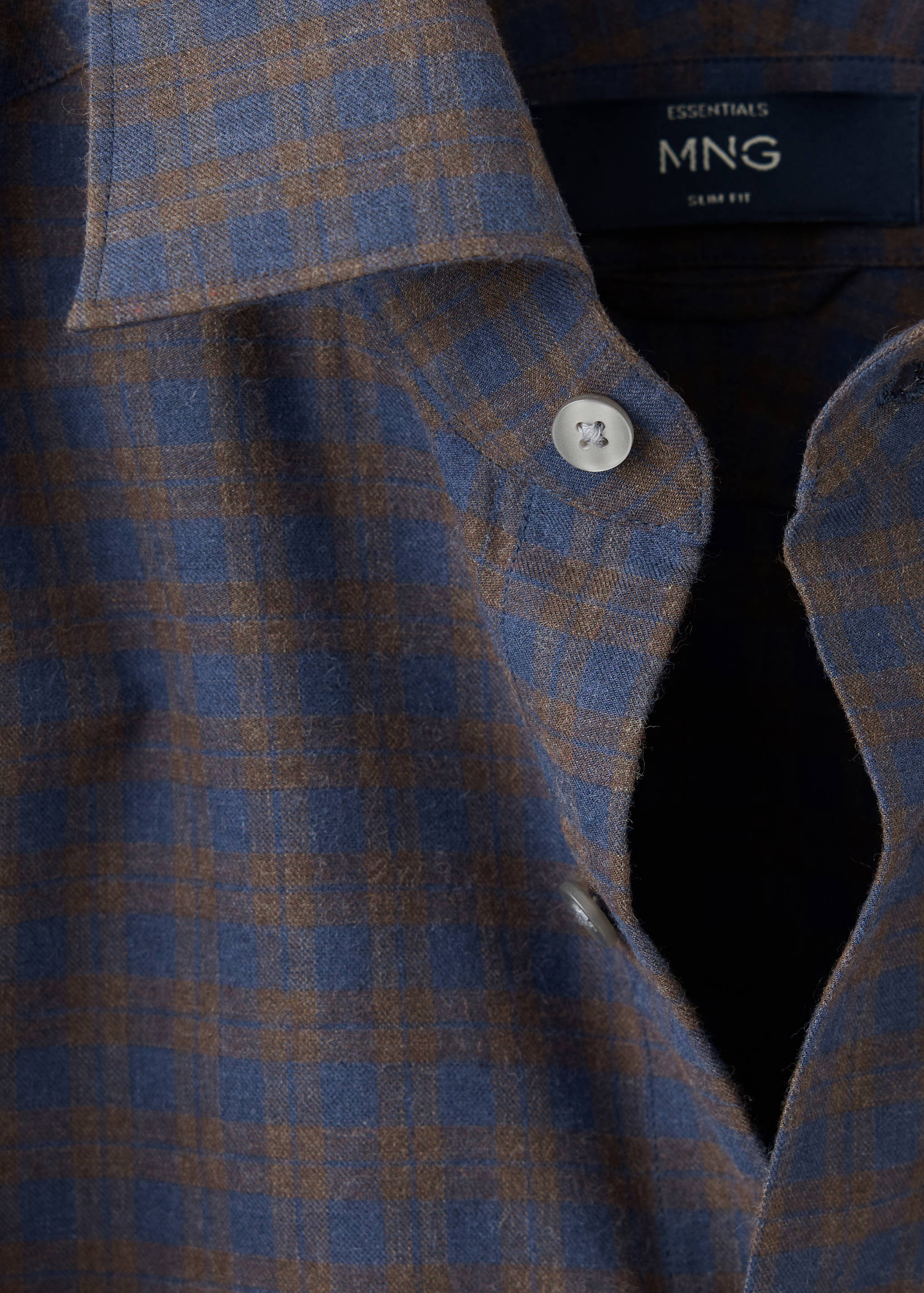 Close-up of a blue and brown checked slim-fit shirt collar and placket.