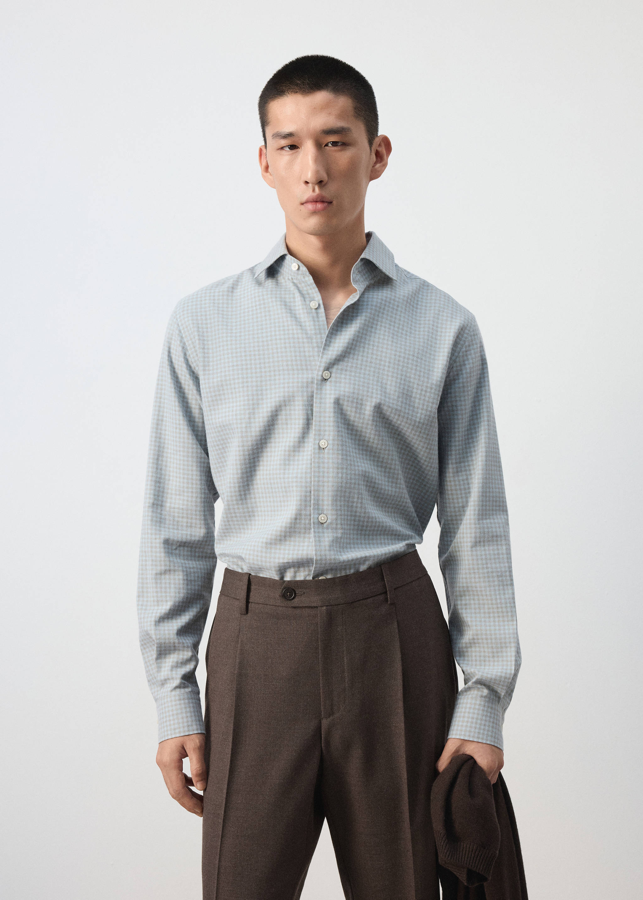 Light blue and white checked shirt with long sleeves and classic collar.