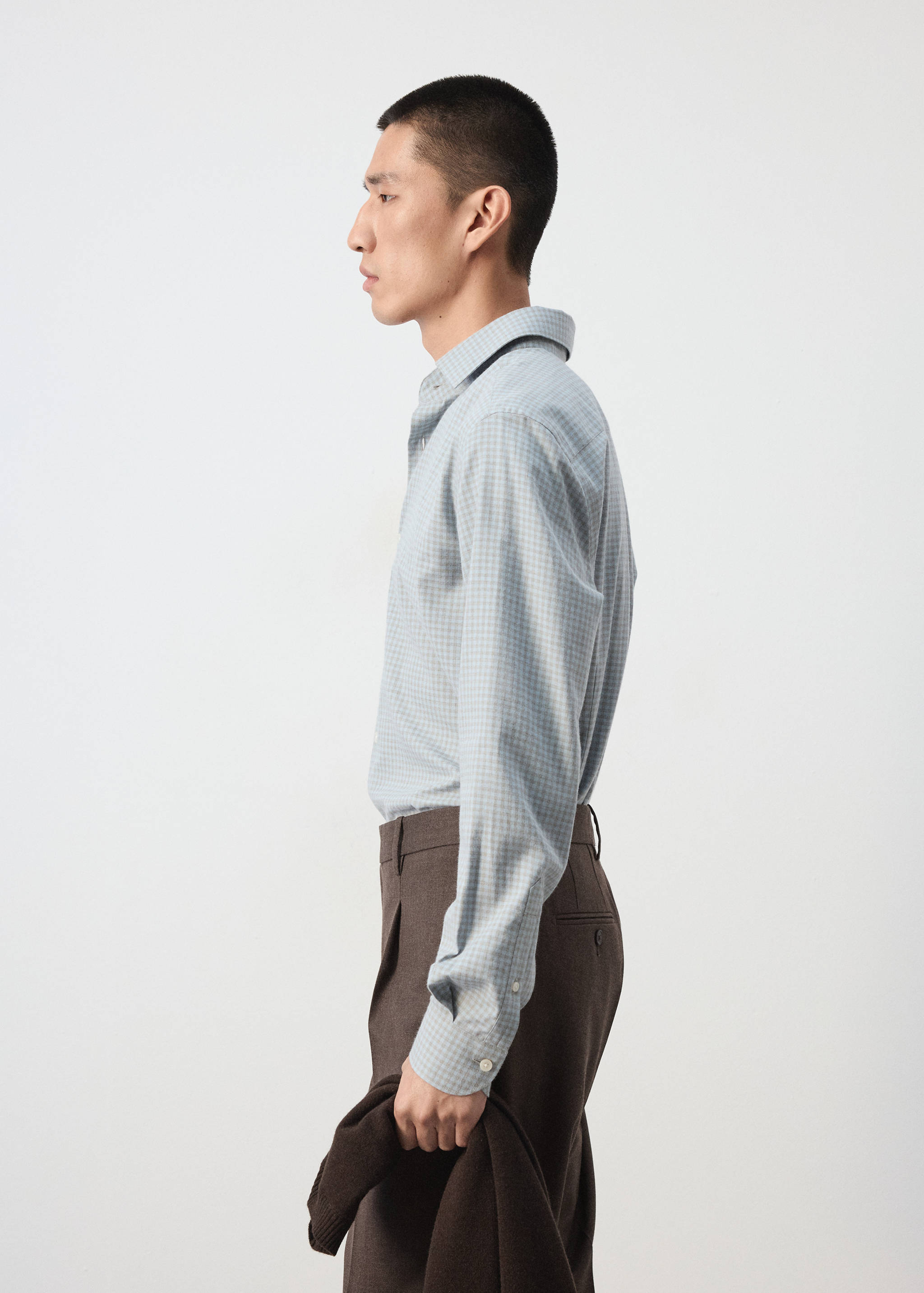 Light blue and white checked shirt with long sleeves and a classic collar.