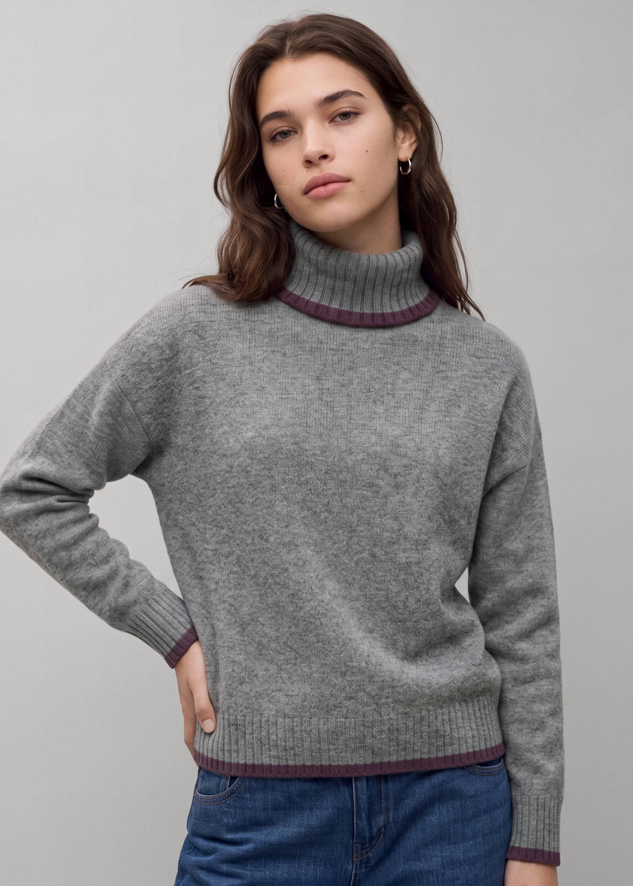 Grey knitted roll-neck jersey with contrasting dark plum trim on the cuffs, hem, and collar.
