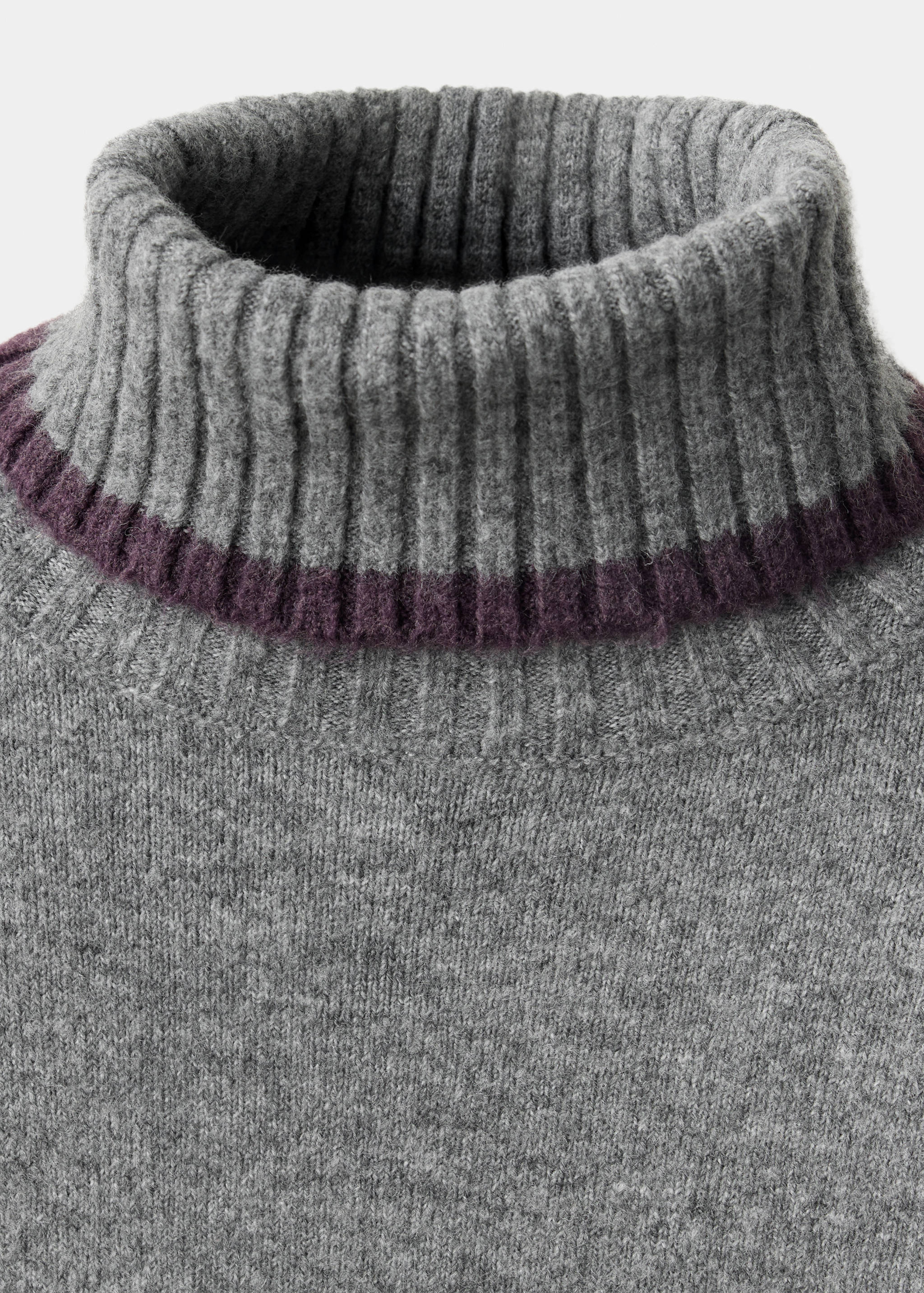 Grey knitted jumper neck detail with a ribbed roll neck and dark purple stripe.