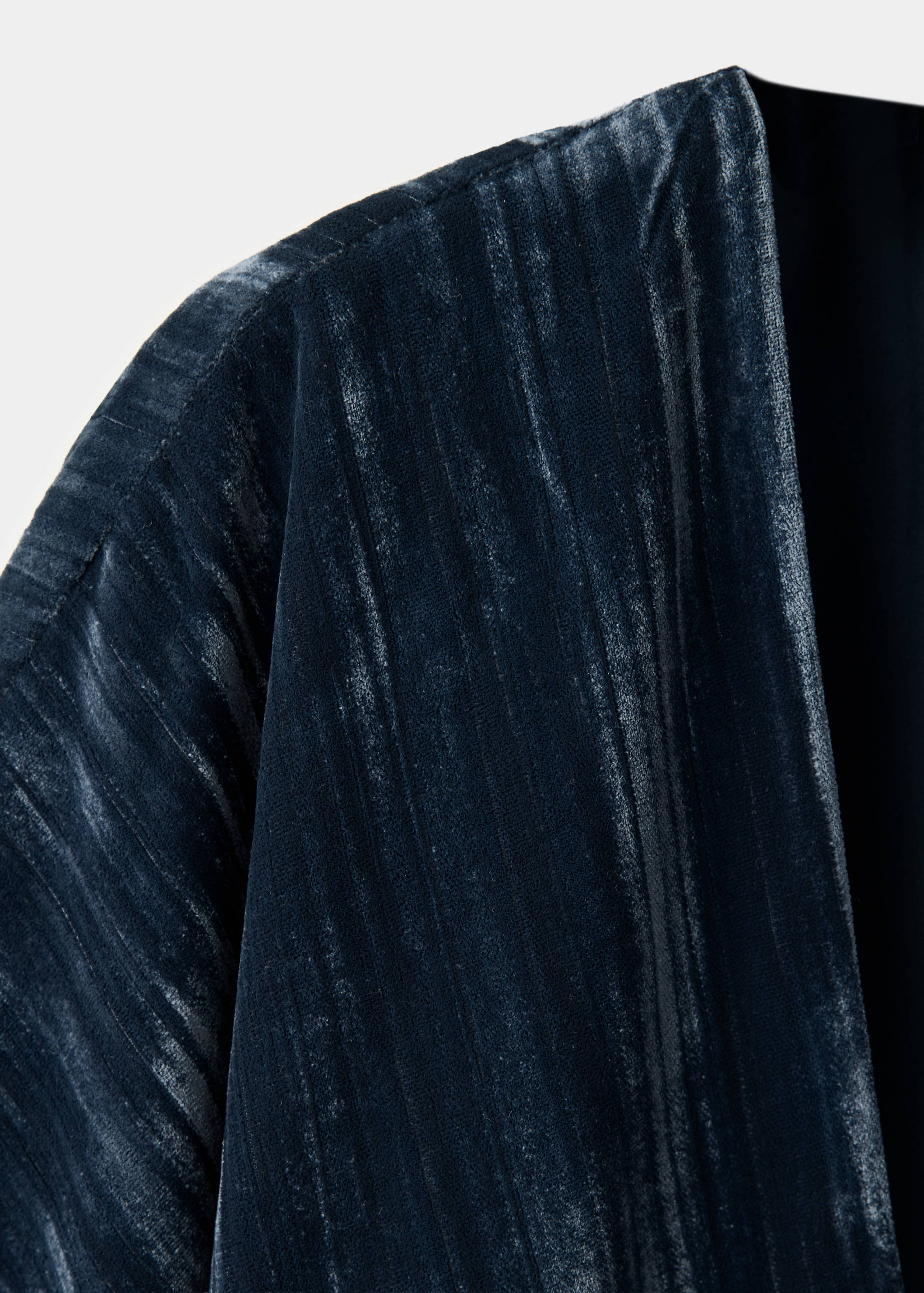 Dark blue velvet blazer fabric detail close-up.