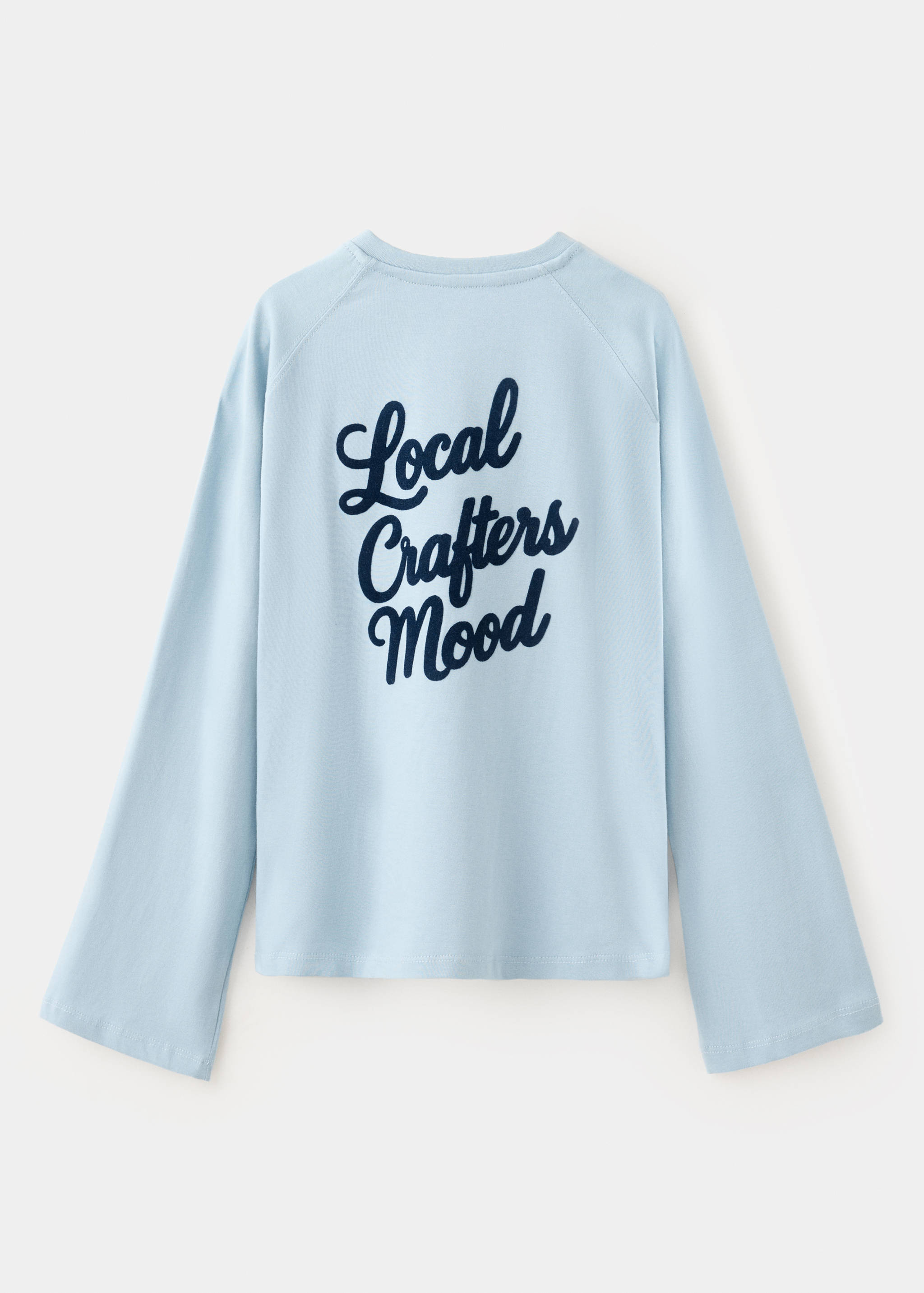 Light blue long-sleeved t-shirt seen from the back, with dark navy script text.