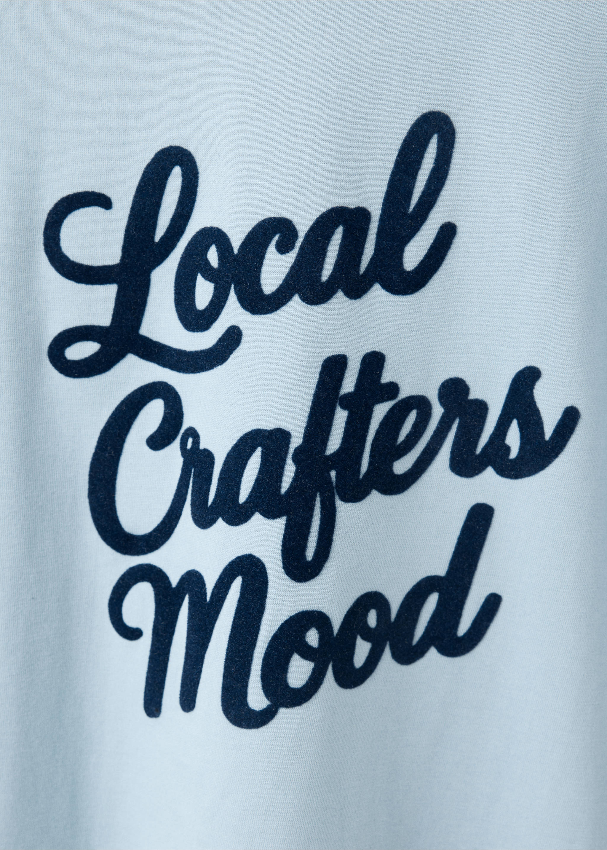 Close-up of a light blue t-shirt with dark text., Sky Blue. Ref: 37048282-00.