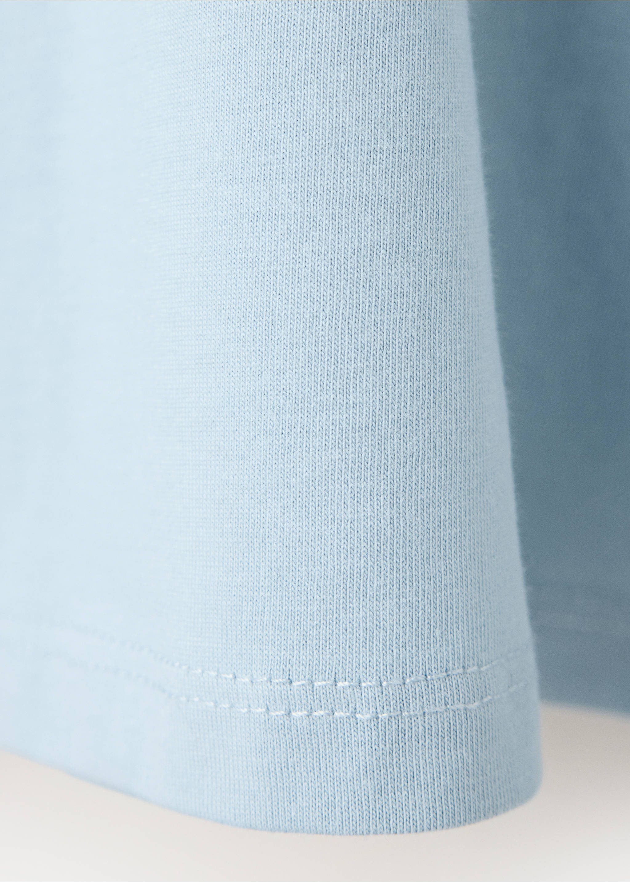 Close-up of the light blue cotton t-shirt fabric and hem., Sky Blue. Ref: 37048282-00.