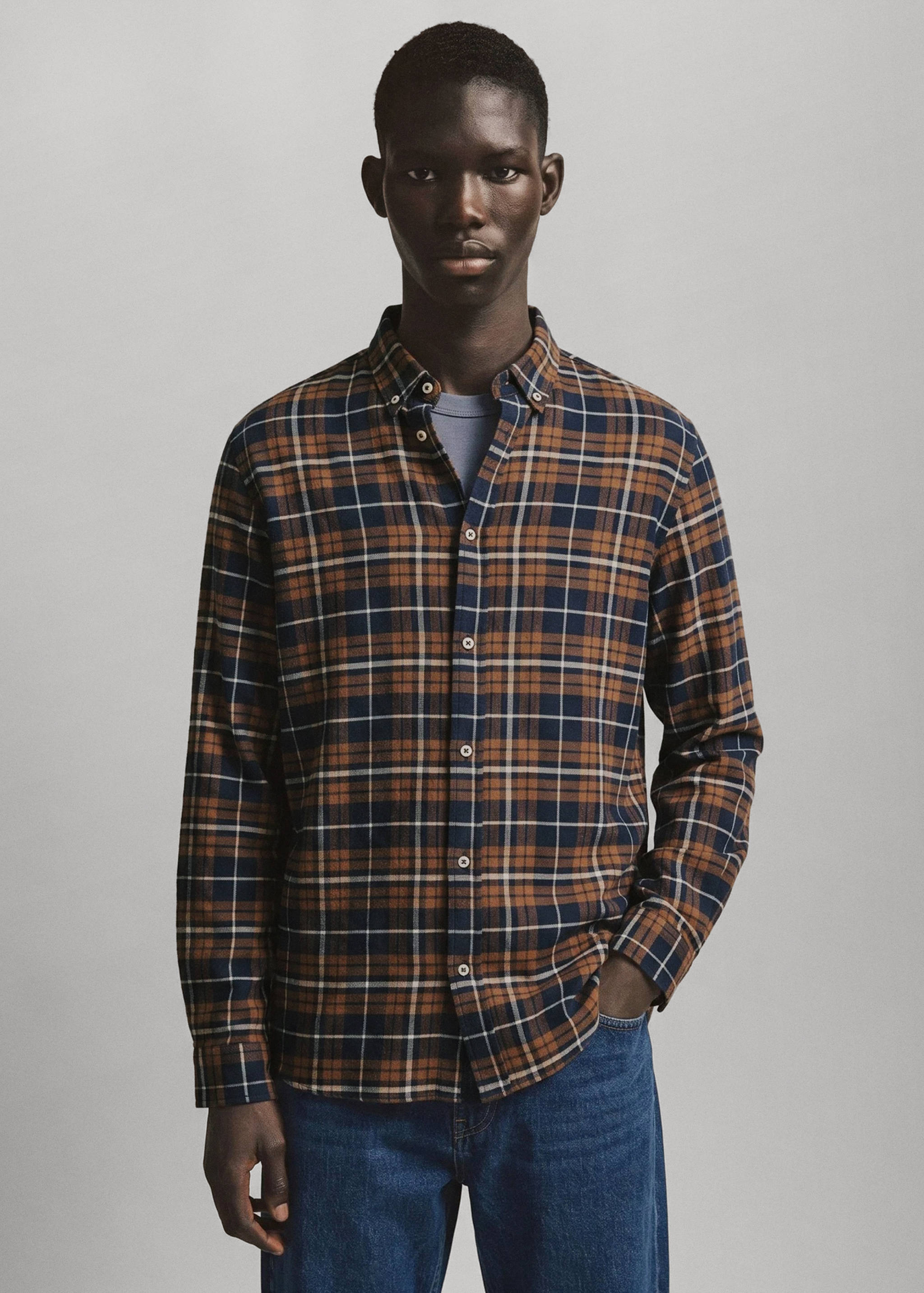 Brown, navy and white plaid long-sleeved shirt with buttoned collar.