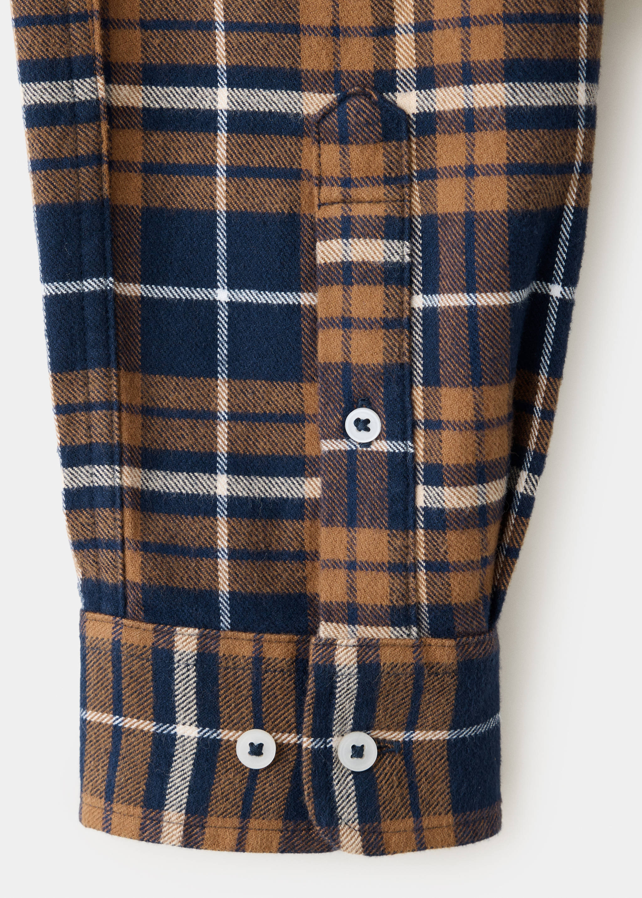 Brown and navy check shirt sleeve detail with buttoned cuff.
