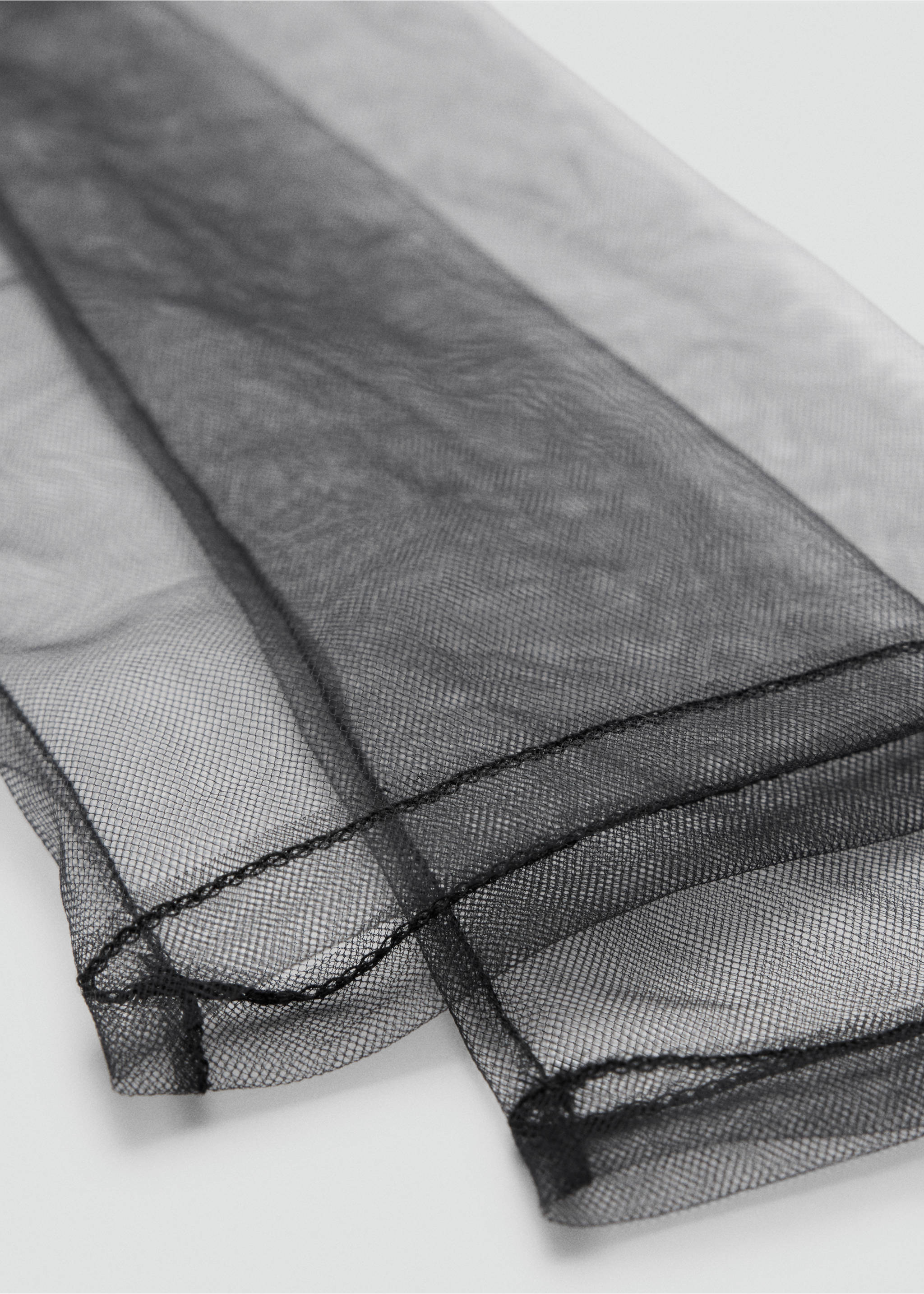 Close-up of sheer black tulle gloves showing fine seam detail., Black. Ref: 37048633-00.