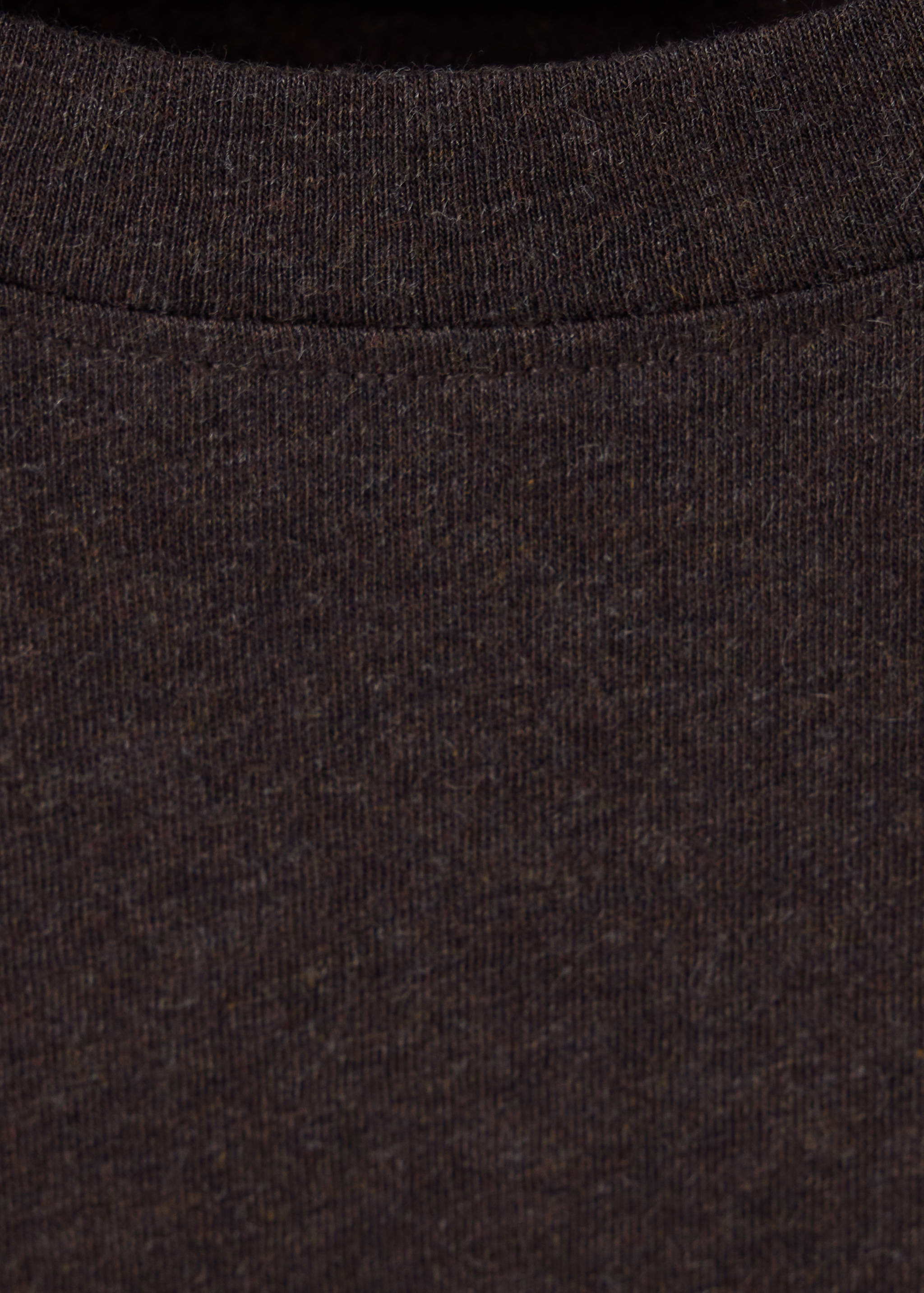 Close-up of a dark brown t-shirt showing the ribbed crew neckline.