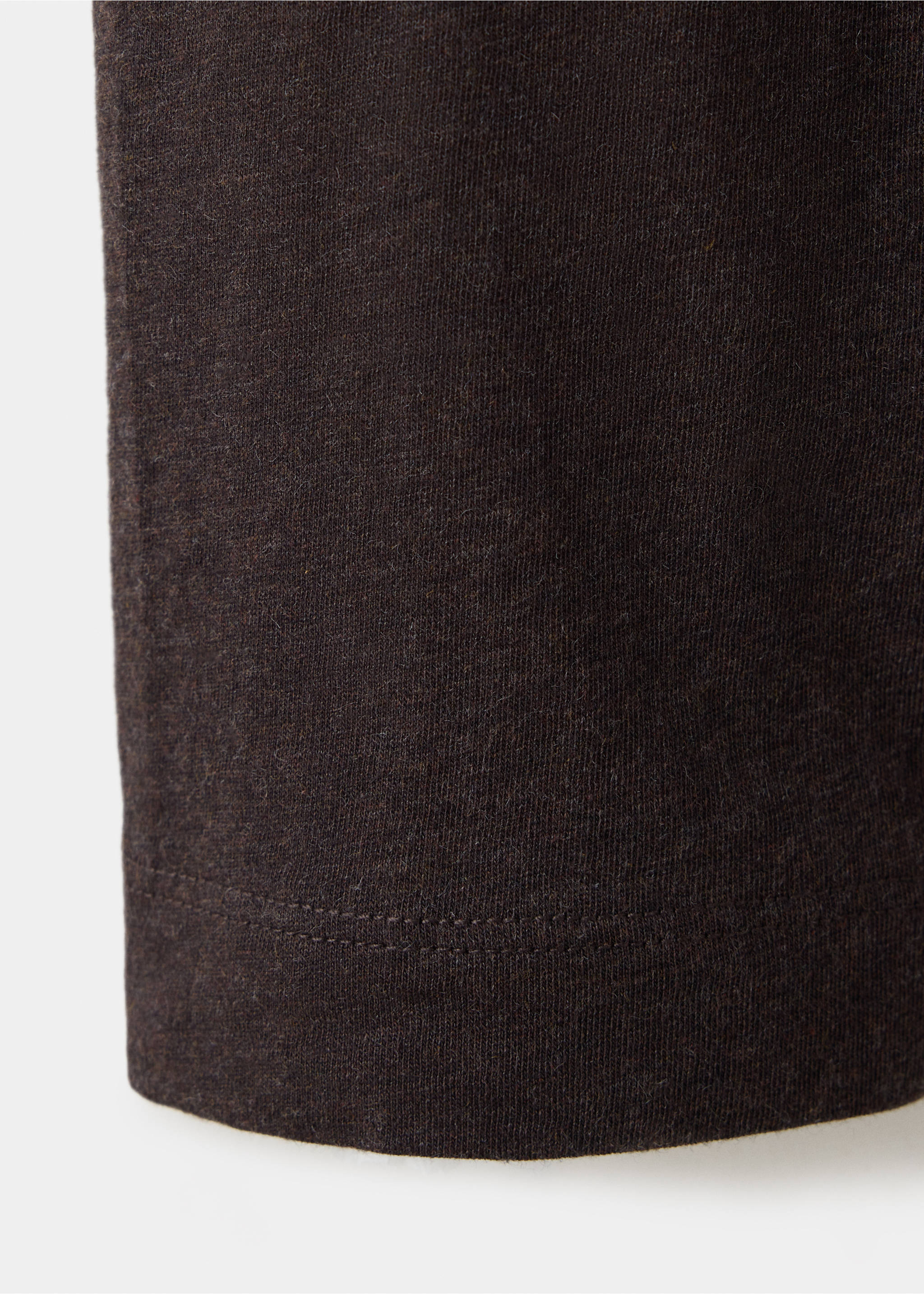 Close-up of the dark brown fabric and hem of a t-shirt., Brown. Ref: 37048636-00.