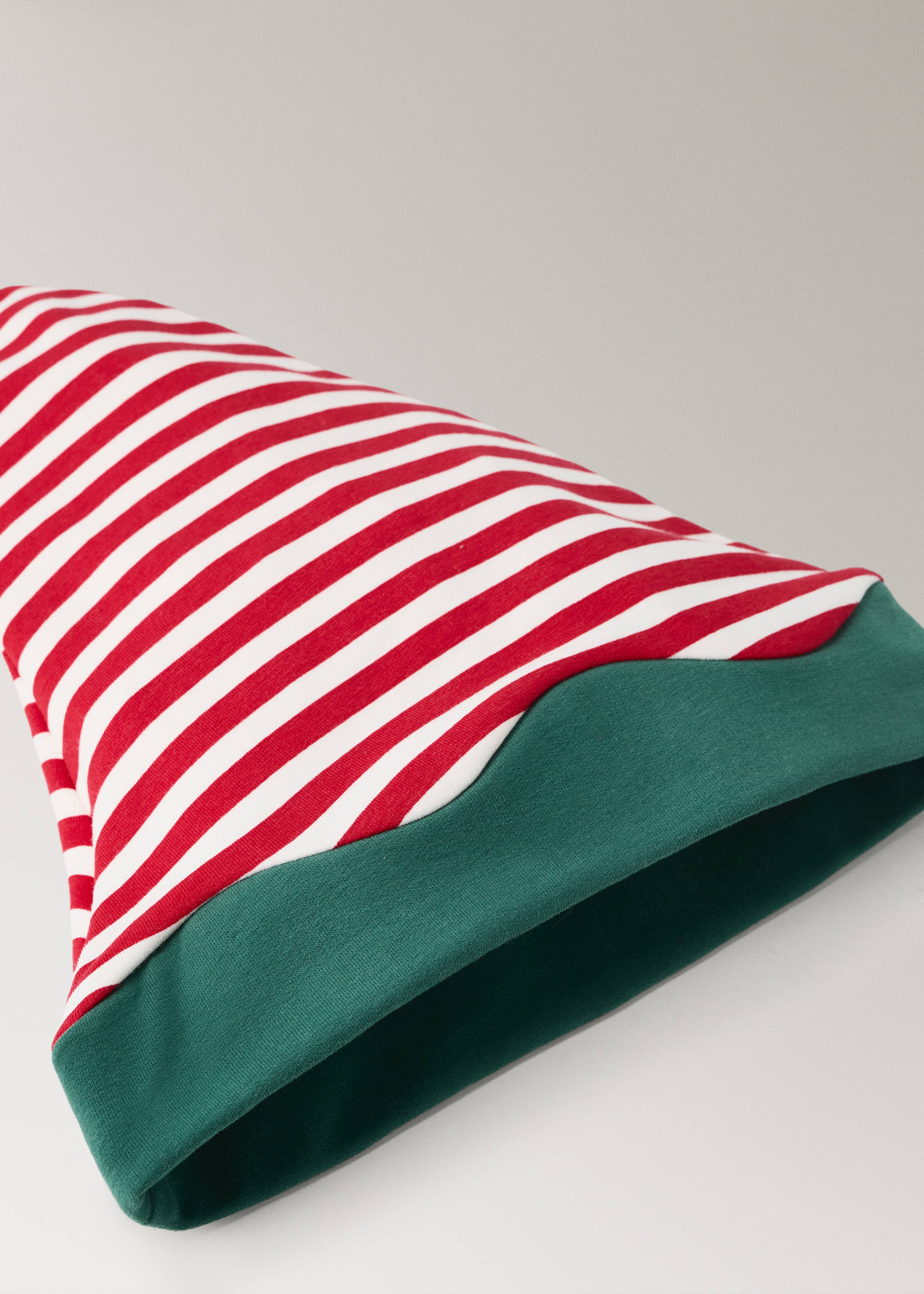 Red and white striped hat with a pointed silhouette and green cuff.