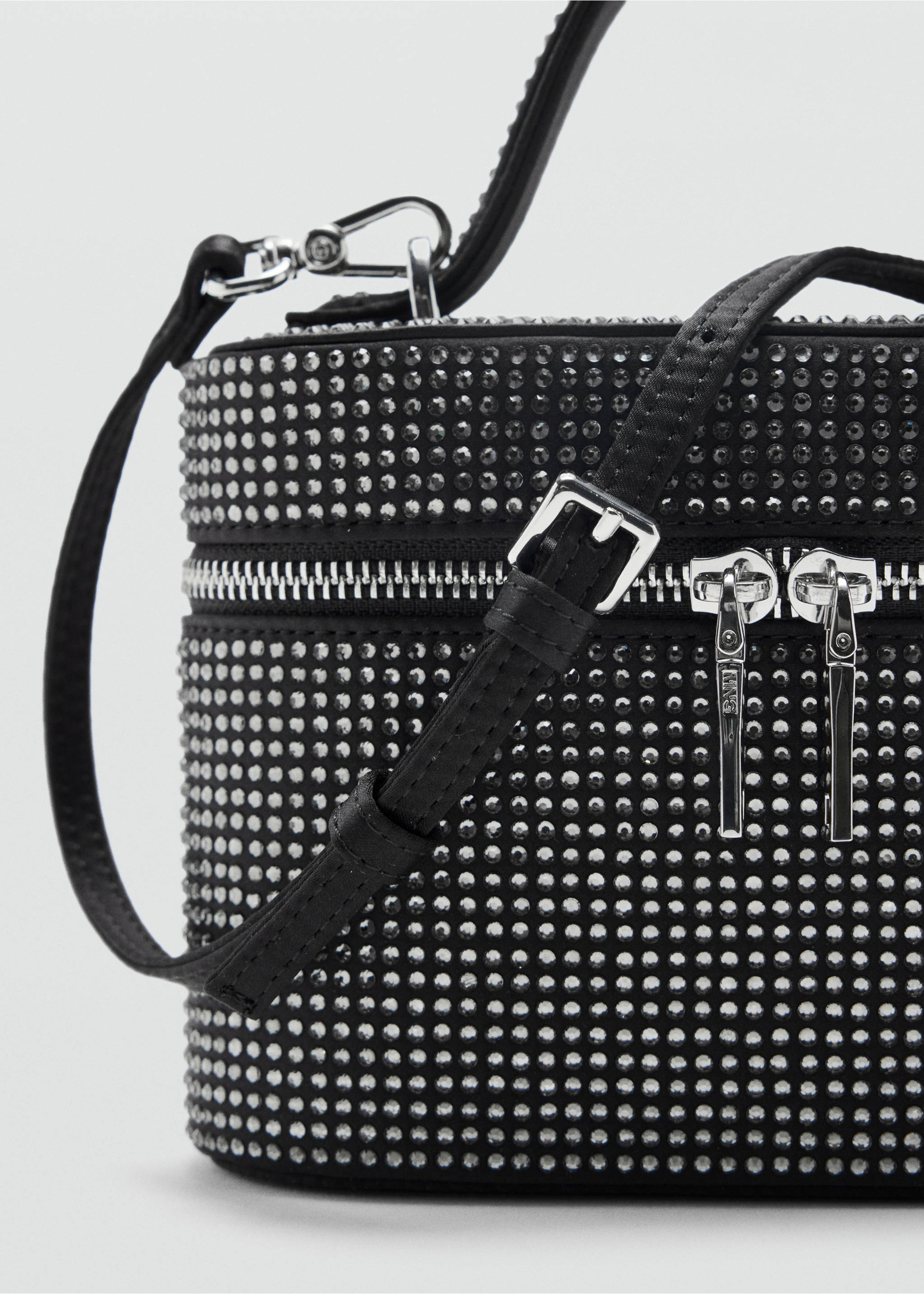 Close-up of a black rhinestone-embellished handbag with a top handle and adjustable strap., Black. Ref: 37049114-00.