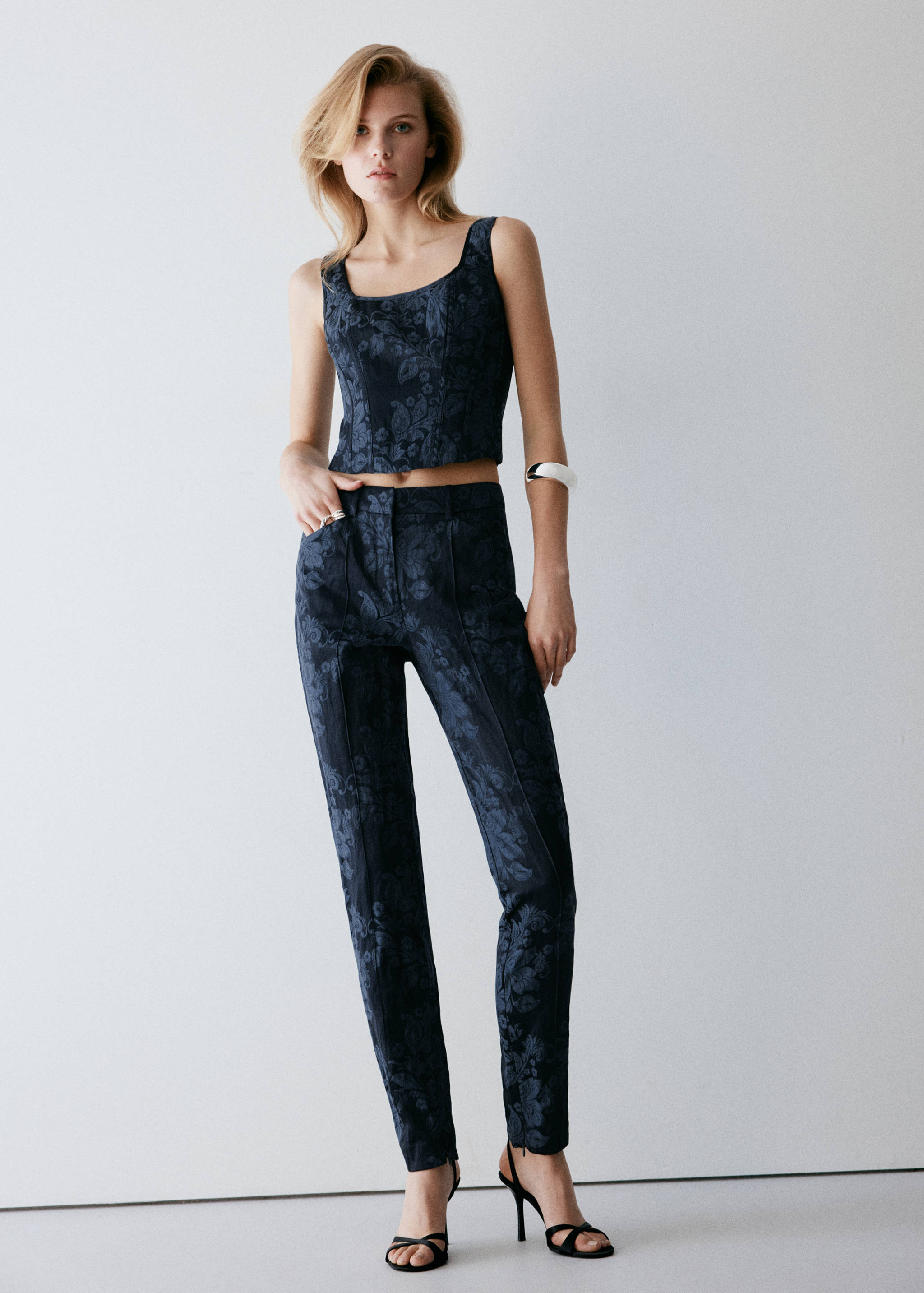 Dark blue floral jacquard crop top with a square neckline, worn with matching trousers.
