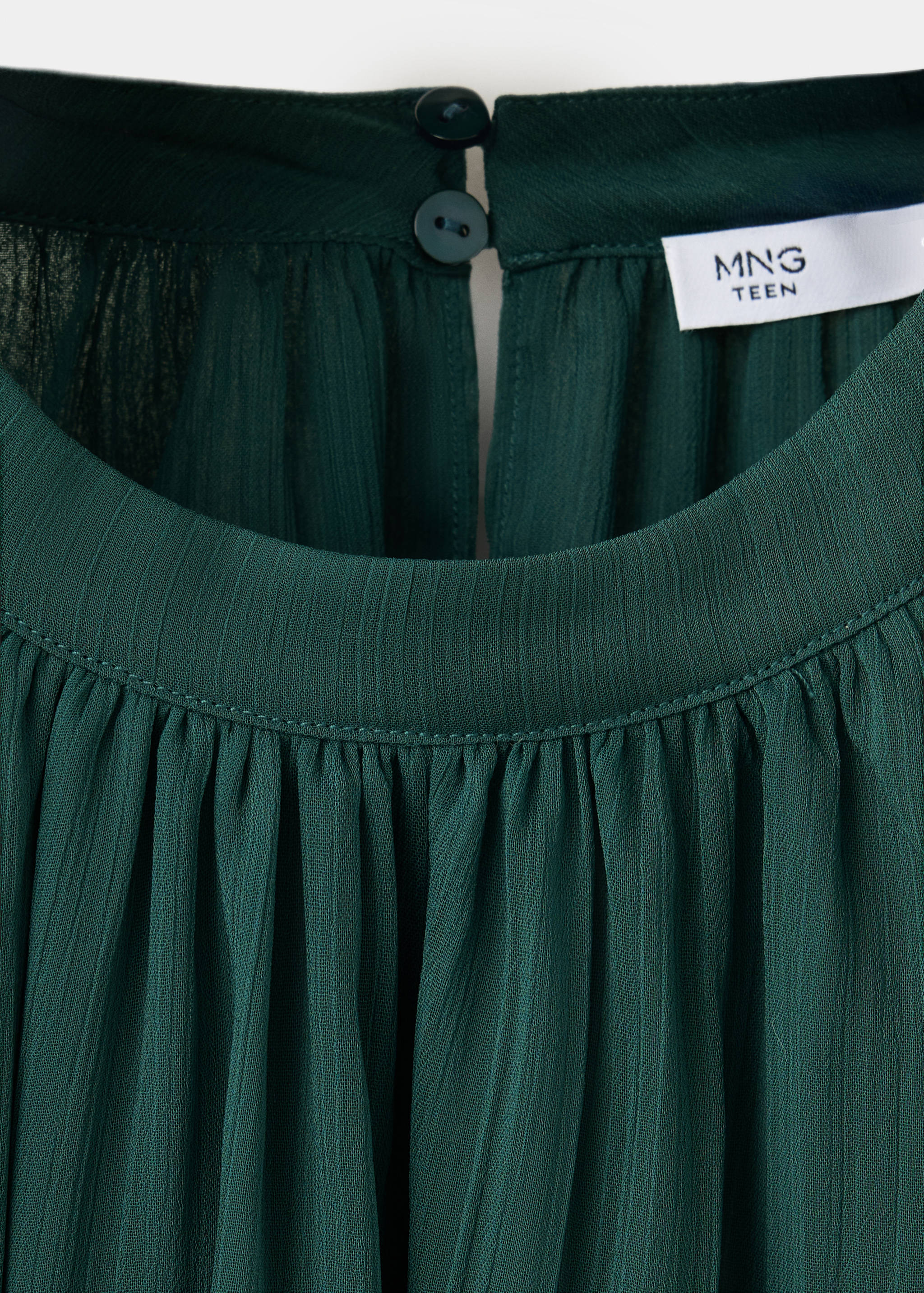 Dark green textured blouse with a round neck and gathered pleats.