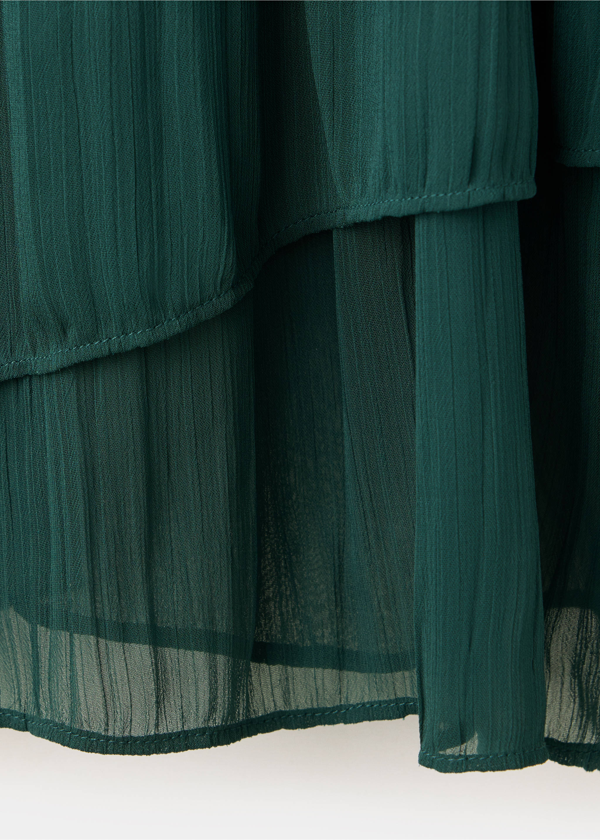 Close-up of the dark green pleated chiffon fabric of a blouse., Petrol Blue. Ref: 37049117-00.