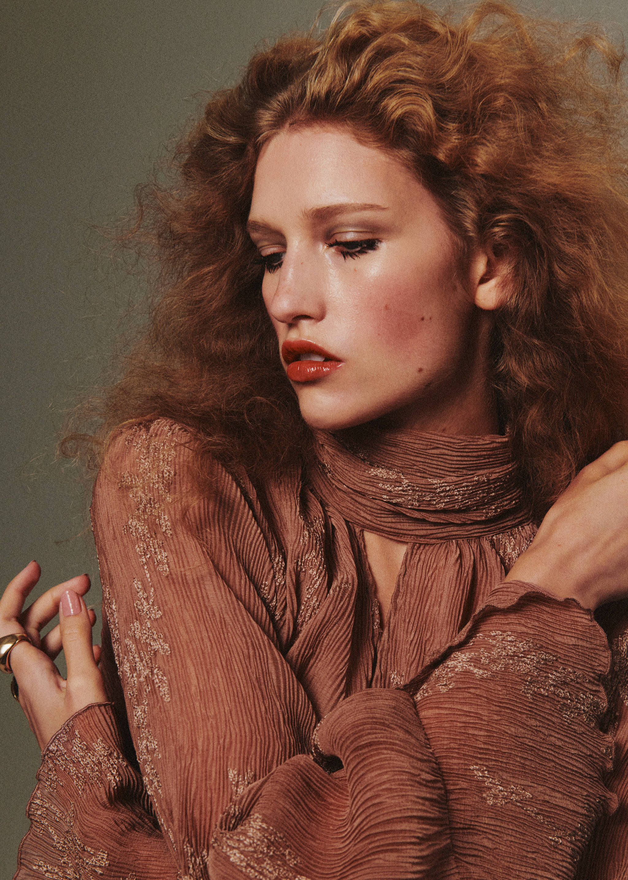 Dusty rose pleated blouse with metallic embroidery and high neck.