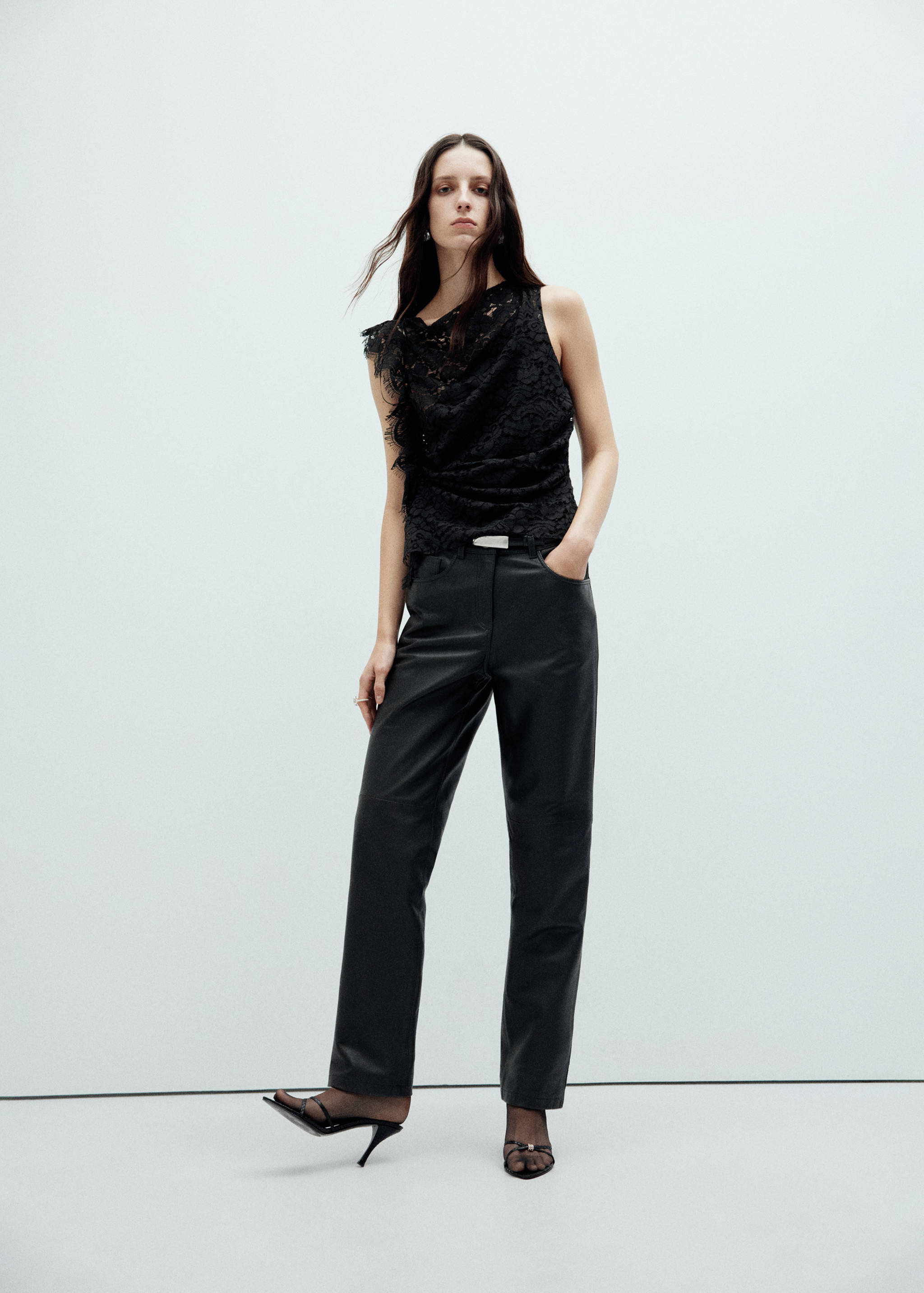 Black lace sleeveless top with asymmetric draped detail and ruching.