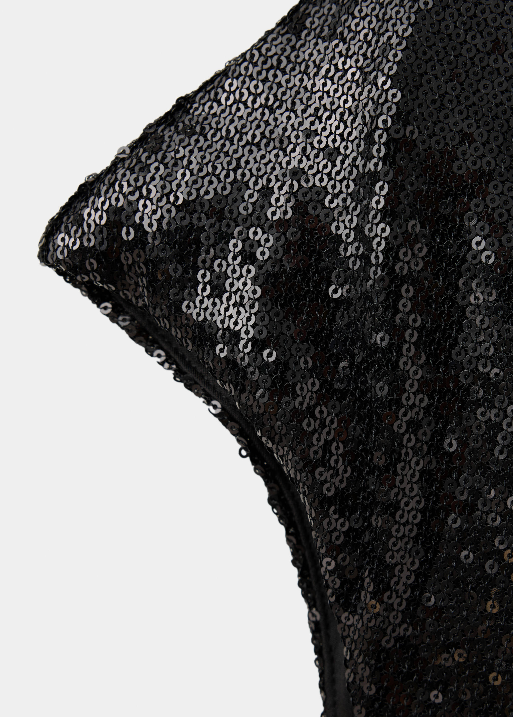Close-up of a black sequin dress detail.