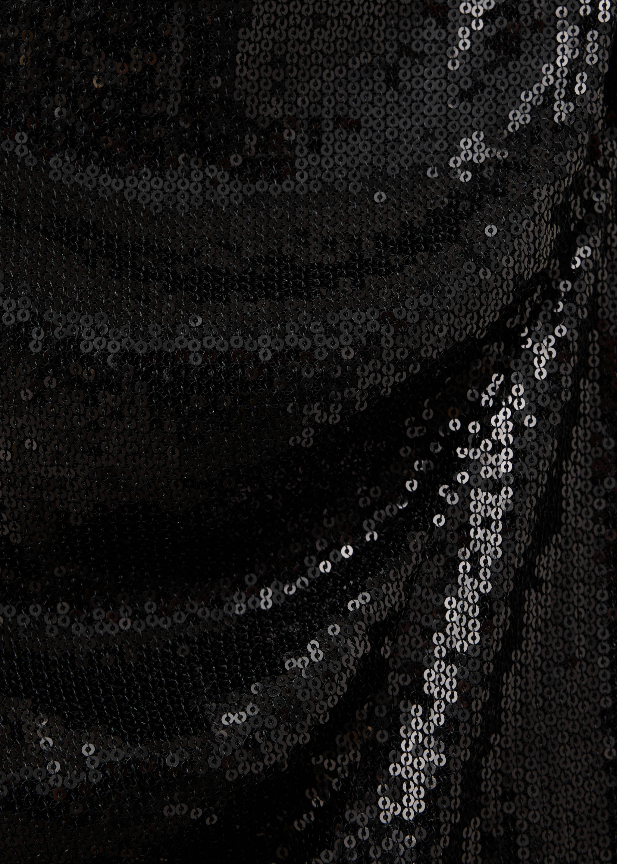 Close-up of black sequinned dress fabric showing the textured, reflective finish., Black. Ref: 37049124-00.