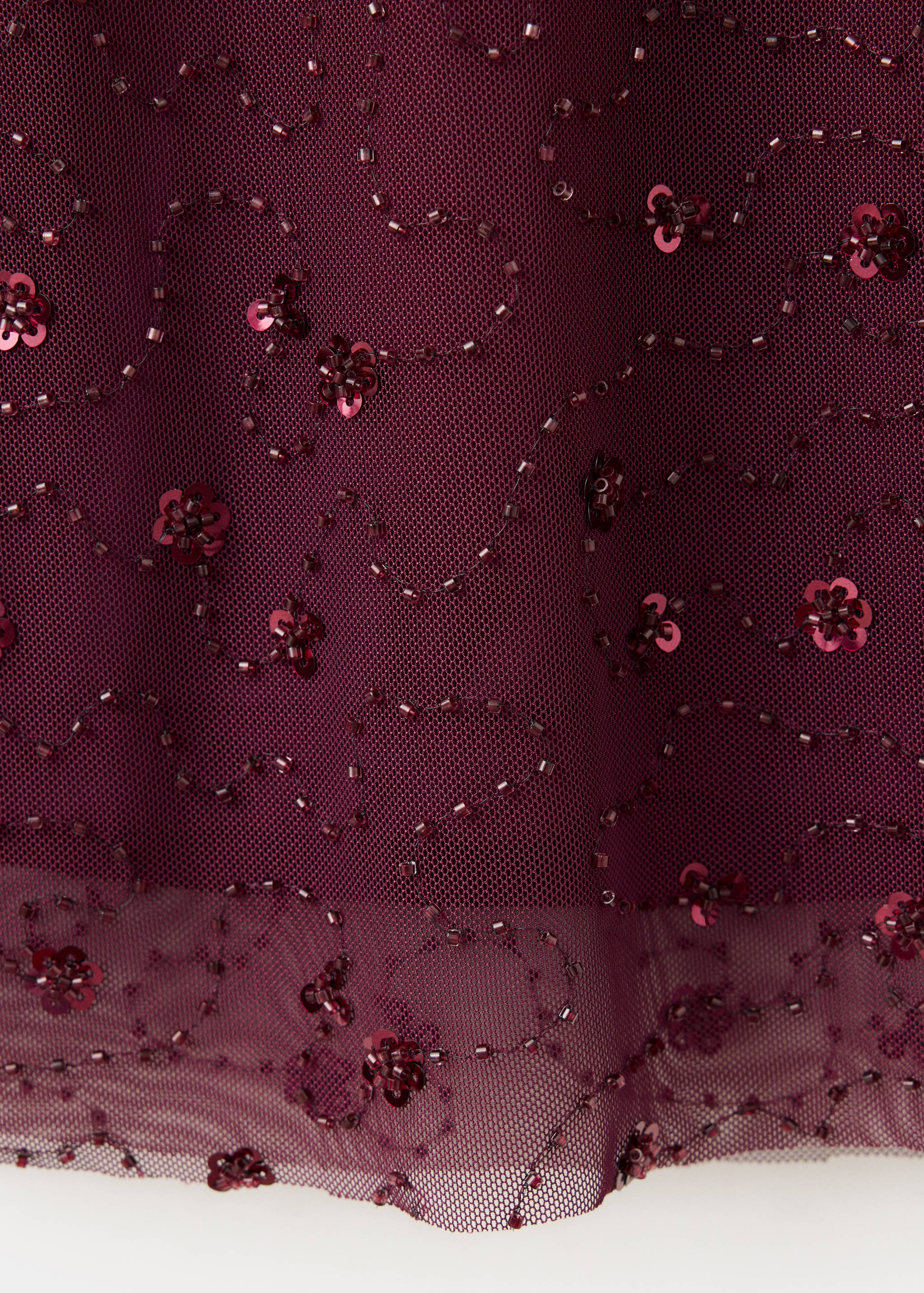 Burgundy mesh dress fabric detail with beaded embroidery and sequins.