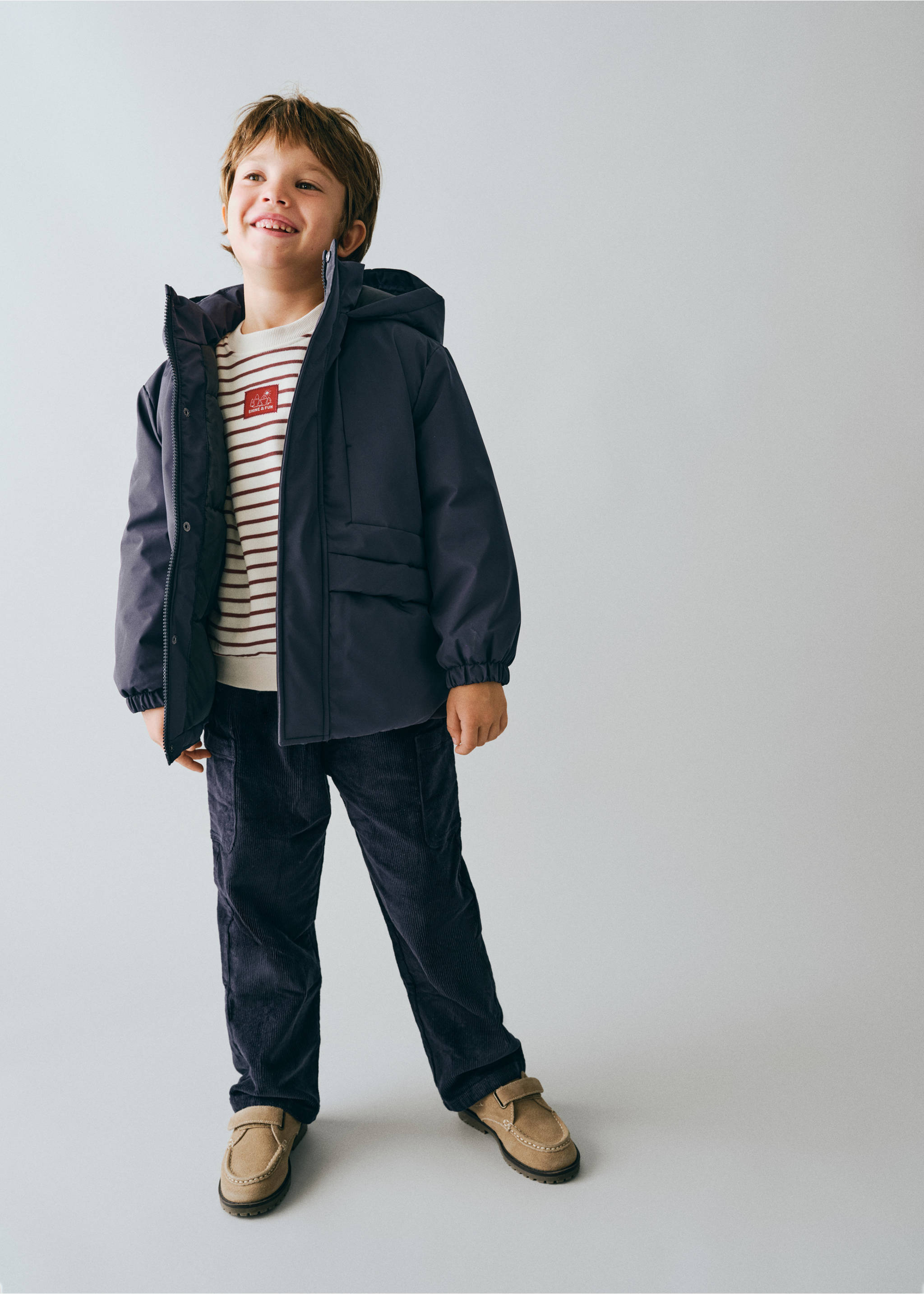Dark navy blue hooded anorak with patch pockets, worn by a young boy., Dark Navy. Ref: 37049128-00.
