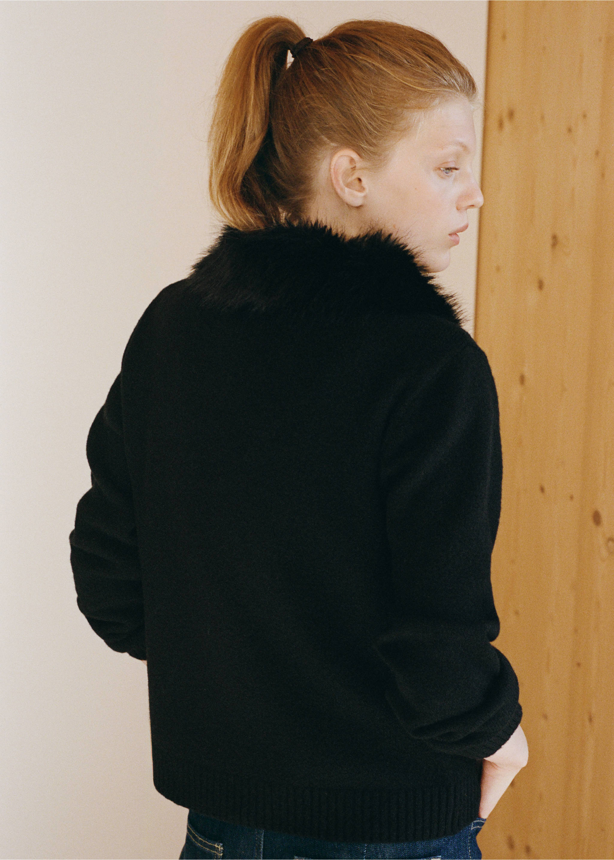 Black cardigan with a plush faux-fur collar, shown from the back., Black. Ref: 37049135-00.