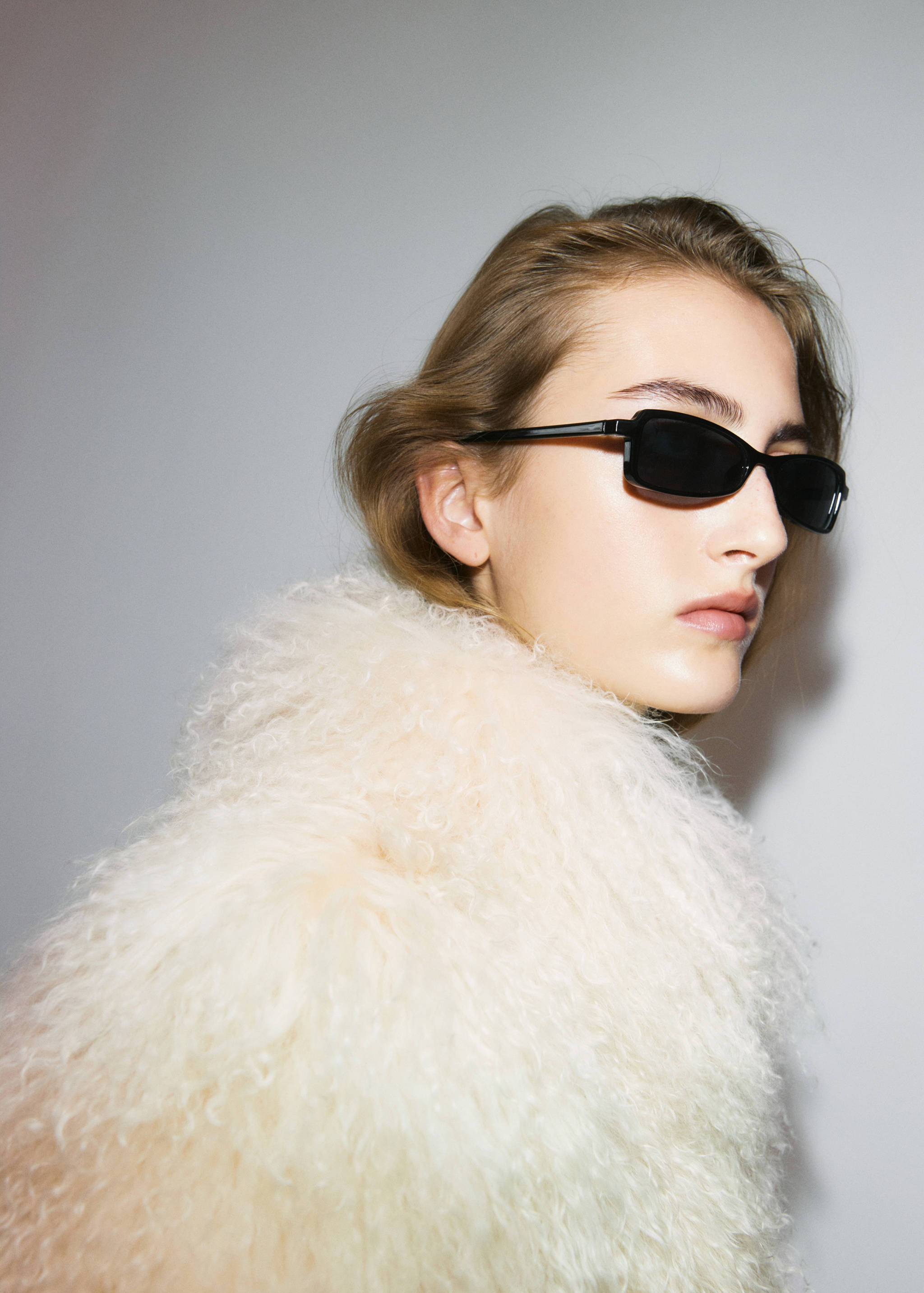 Black rectangular sunglasses with dark lenses.