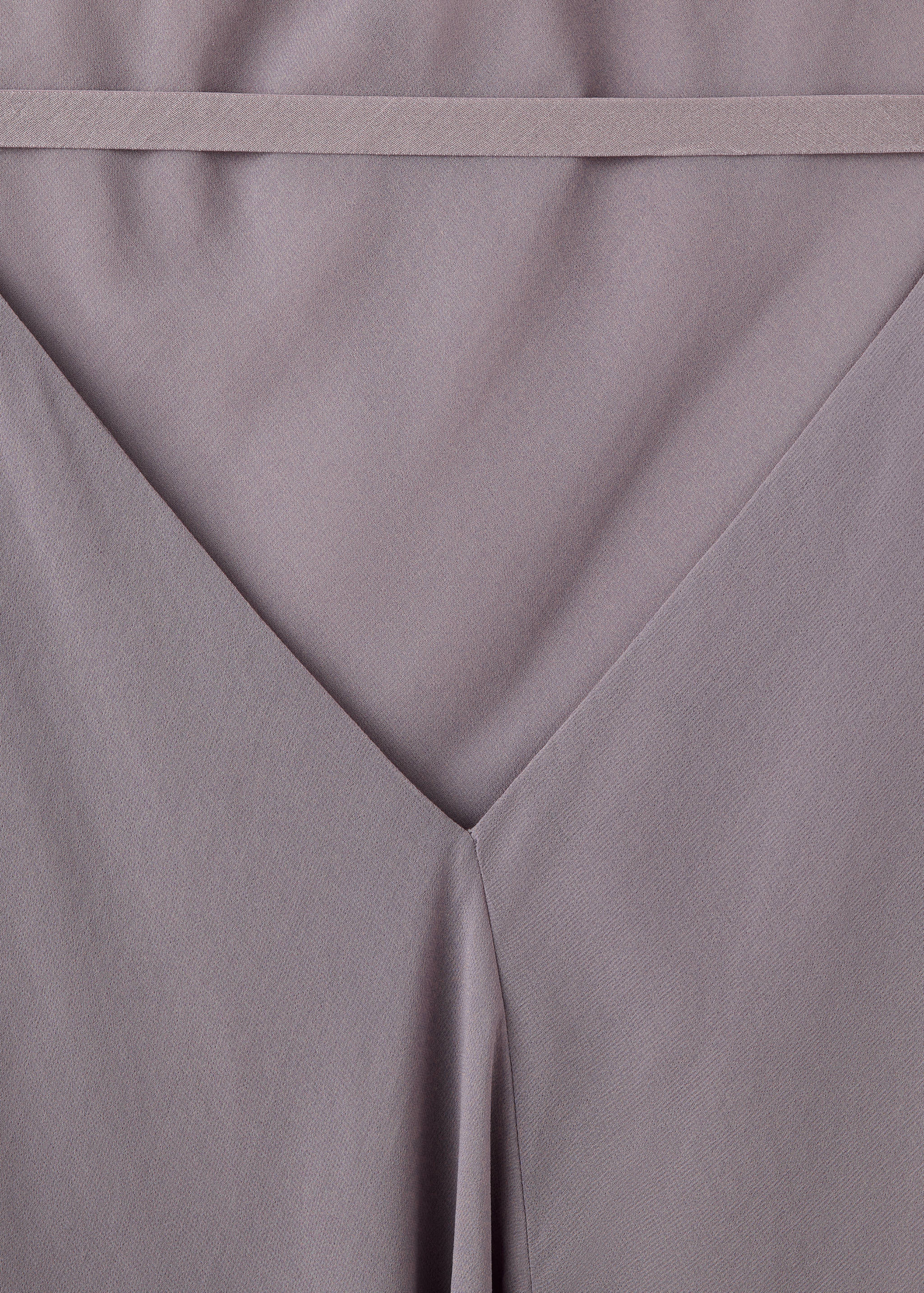 Mauve dress fabric detail showing the V-neckline and horizontal band.