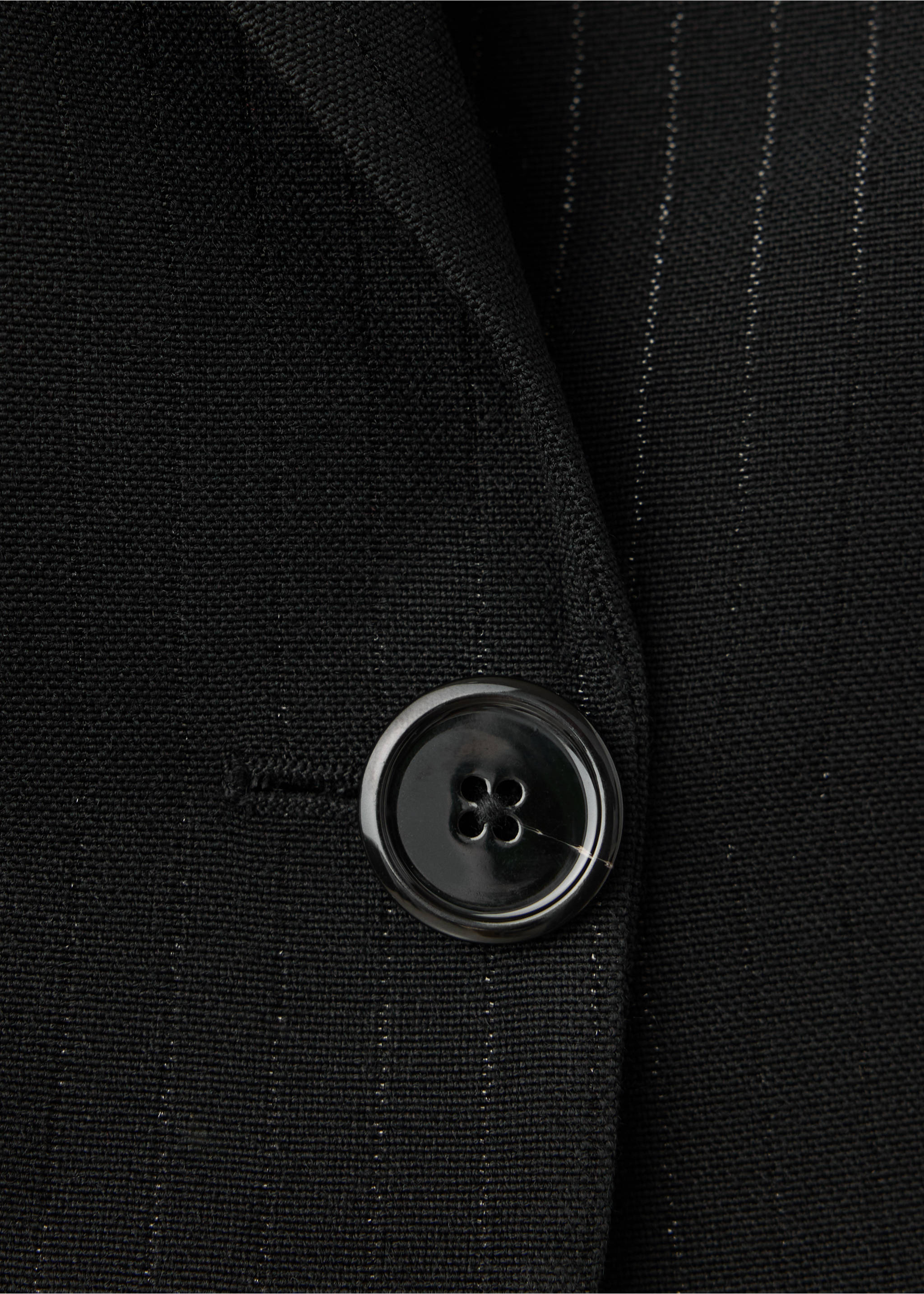 Close-up of a black pinstripe blazer showing the button detail., Black. Ref: 37049144-00.