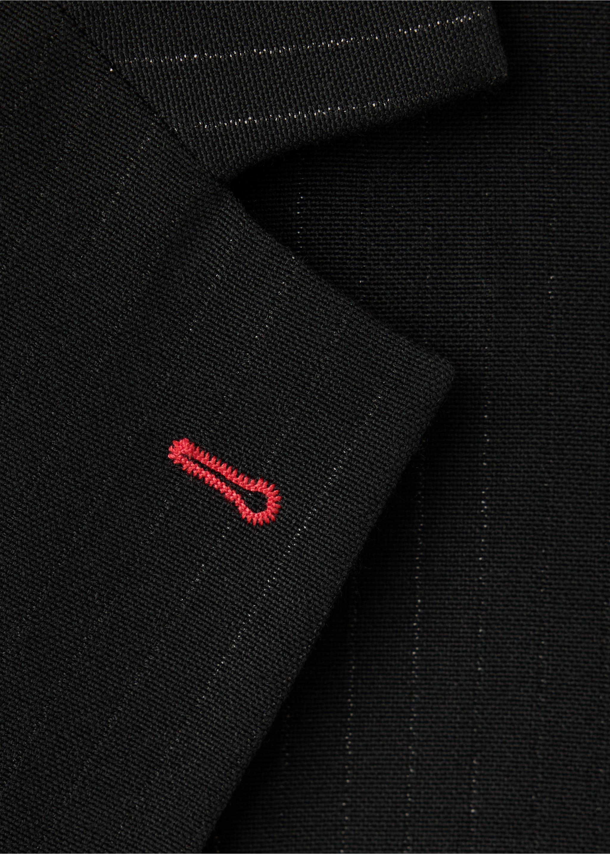 Black pinstripe blazer fabric detail with a red embroidered buttonhole., Black. Ref: 37049144-00.