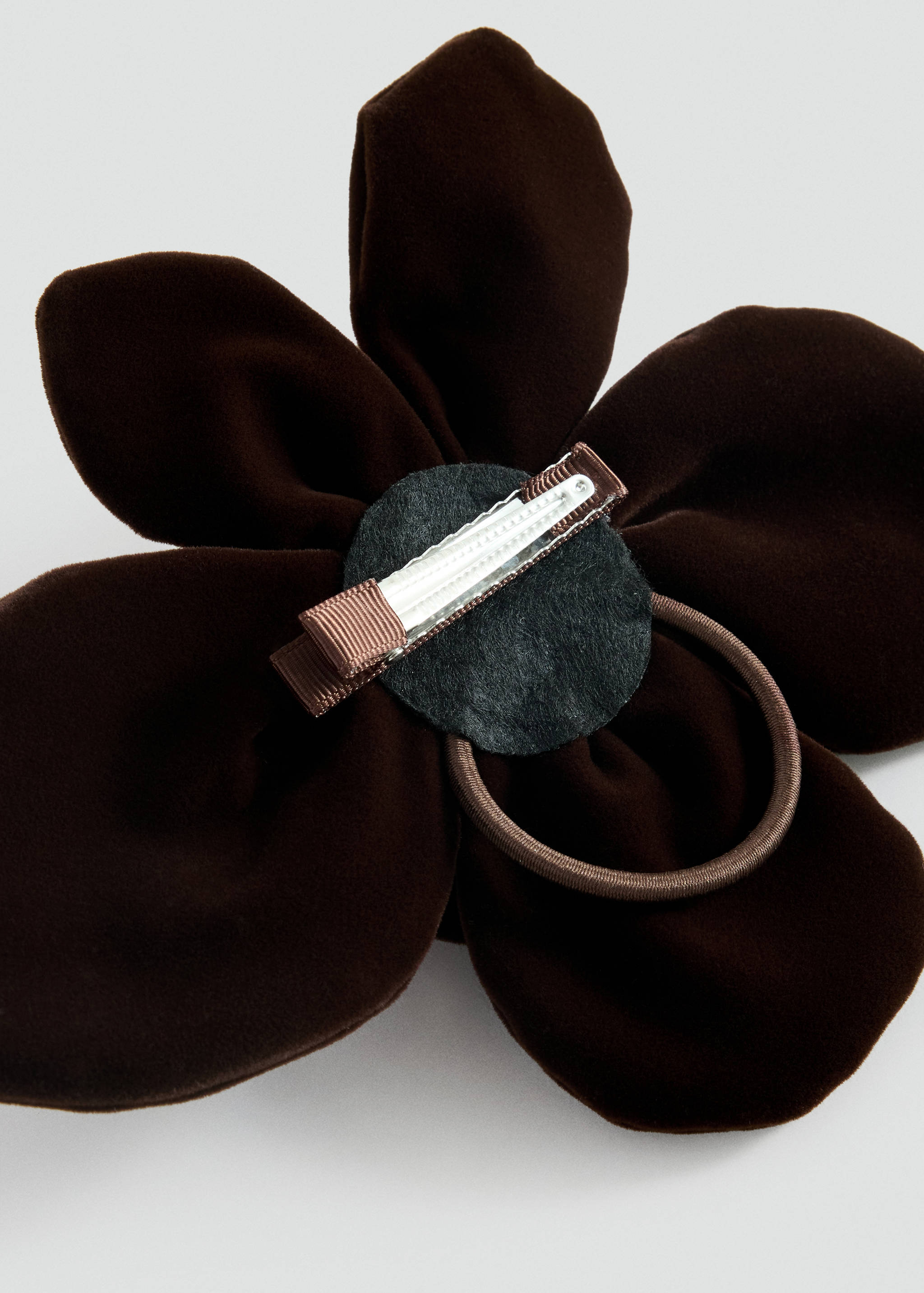 Dark brown velvet flower hair clip with a metal clip and elastic band.
