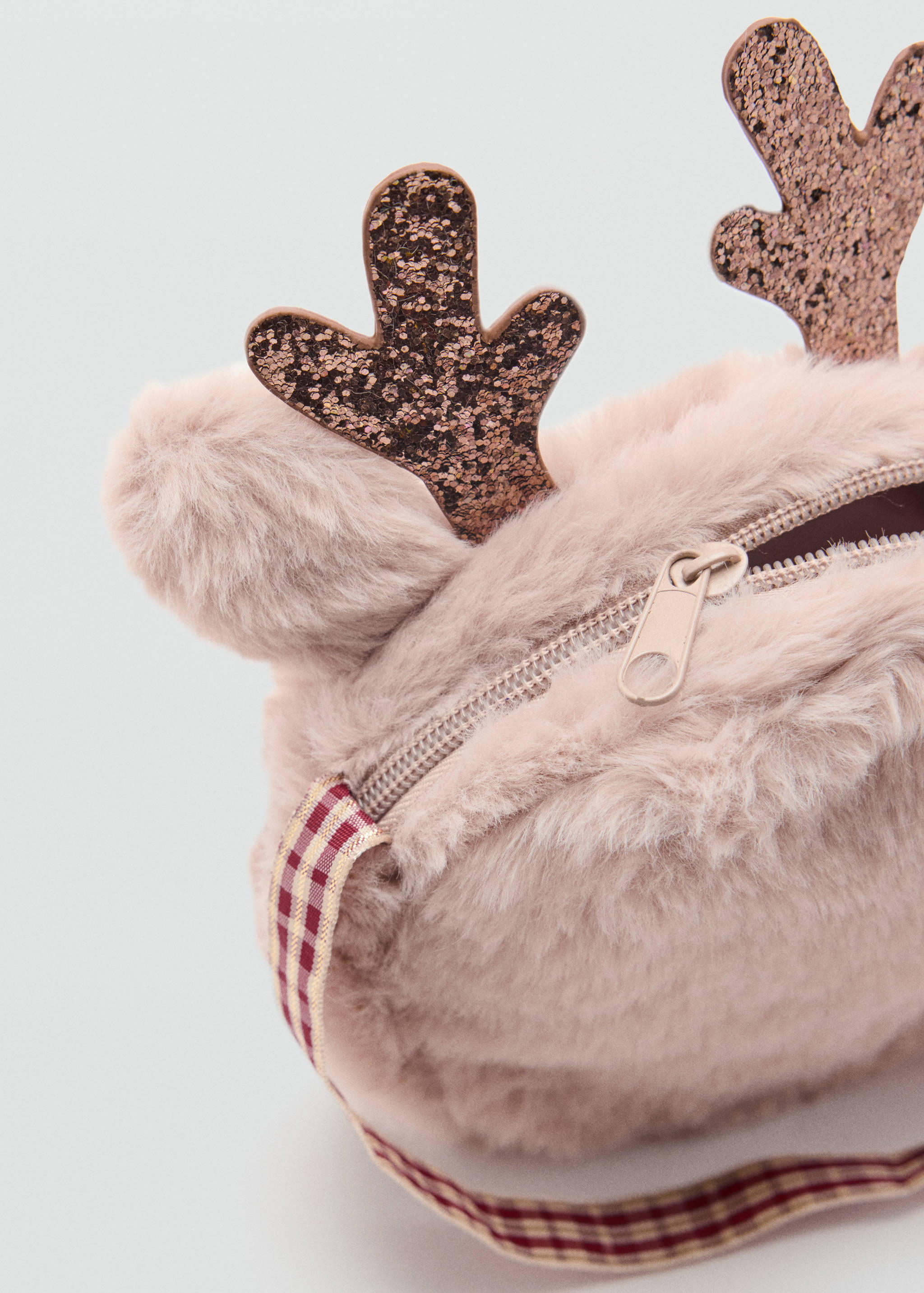 Close-up of a pink faux-fur mini bag with glittery reindeer antlers.