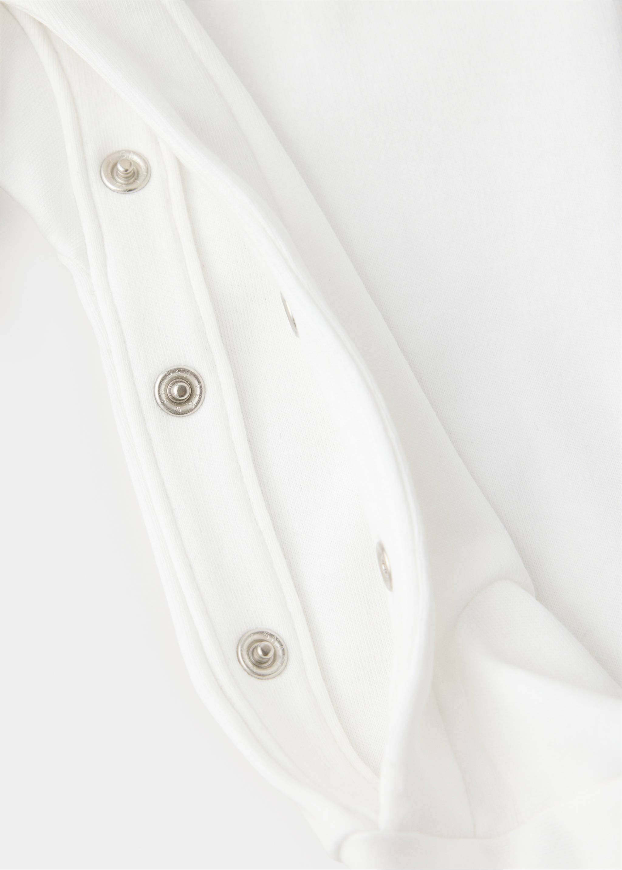 White pyjama fabric and press-stud fastening detail., Off White. Ref: 37049223-00.