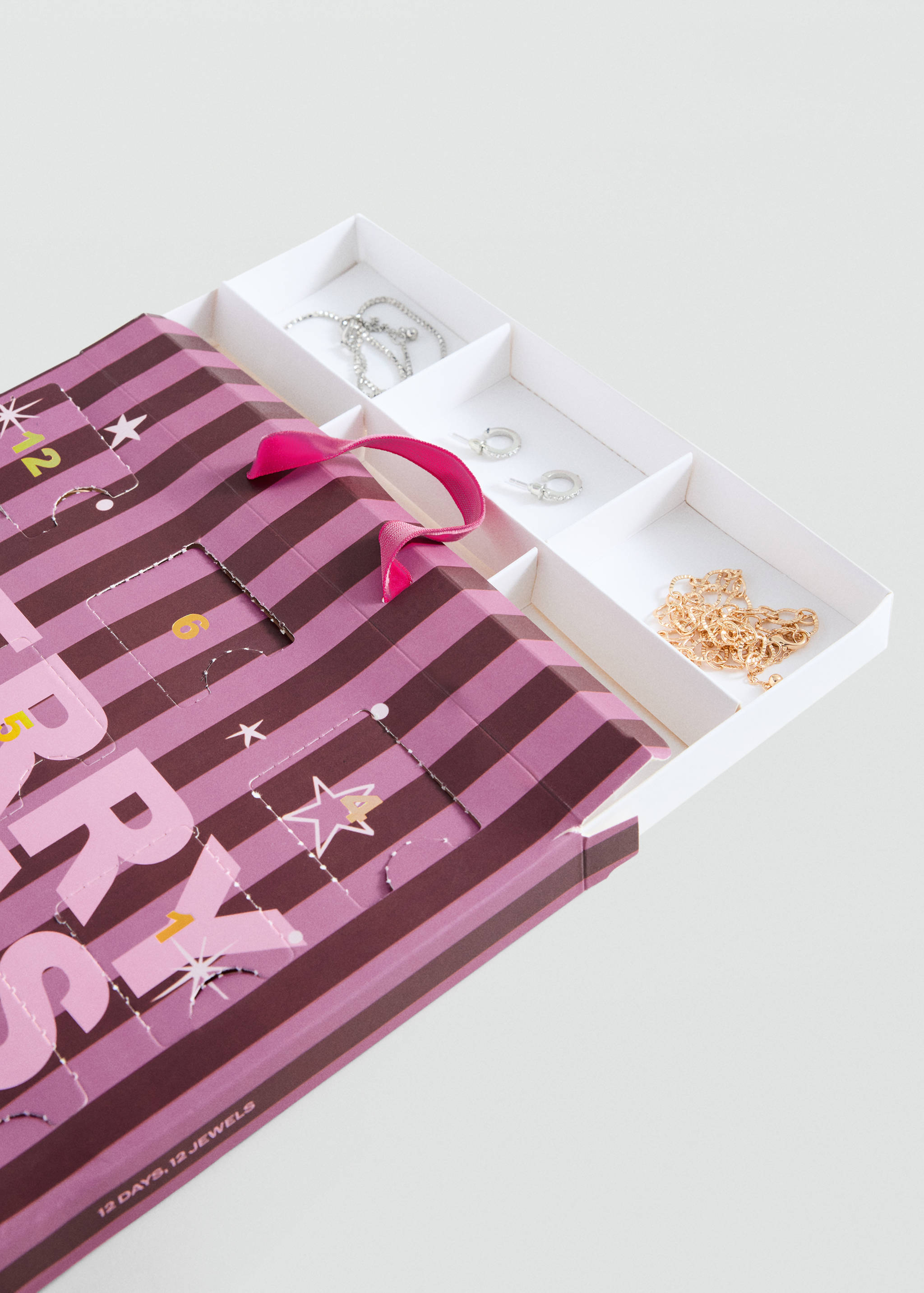 Striped advent calendar gadget with jewelry in open compartments.