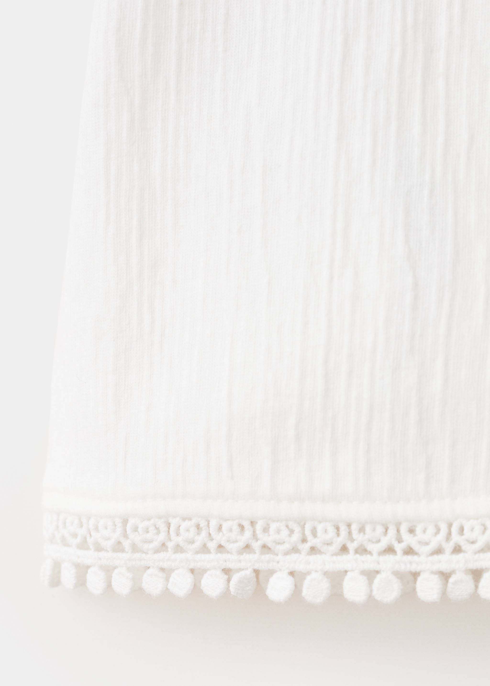 Sleeveless vest with embroidered details - Details of the article 0